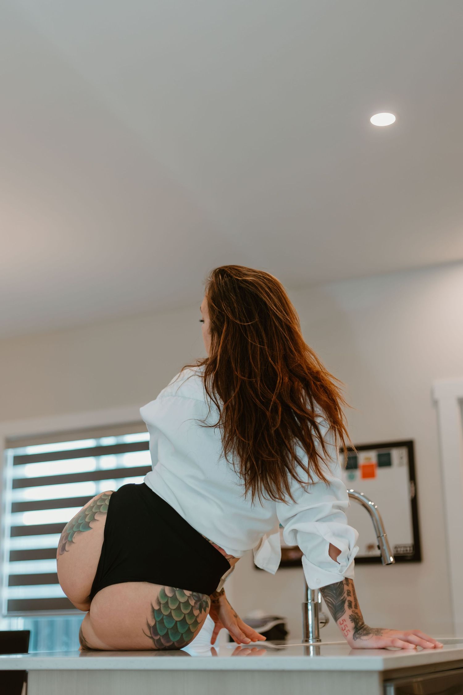 A sequence of photos showing someone bending backwards in a white room with windows and gradually performing a backbend motion.