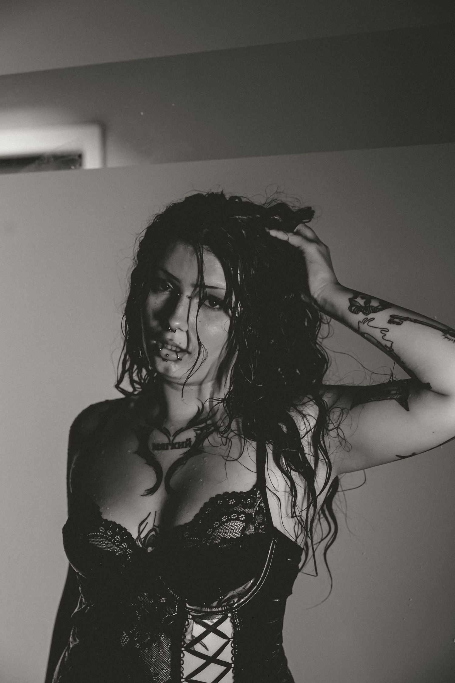 Artistic black and white photo series showing a person with wet hair in dramatic shadows and lingerie.