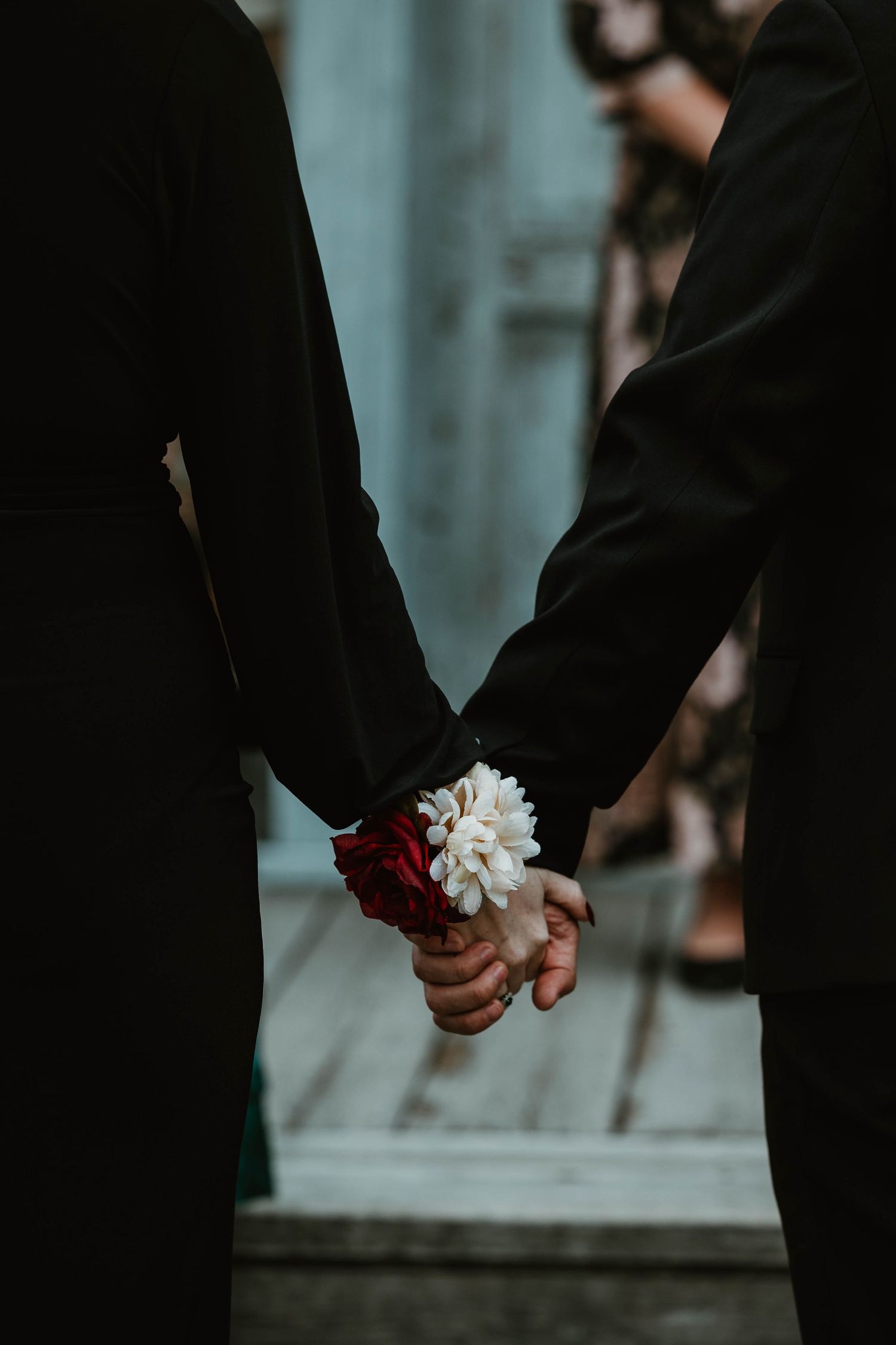 Close-up of hands holding white flower and touching.