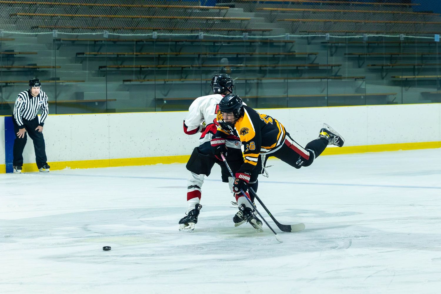 Ice hockey players battling for puck control during intense game action.
