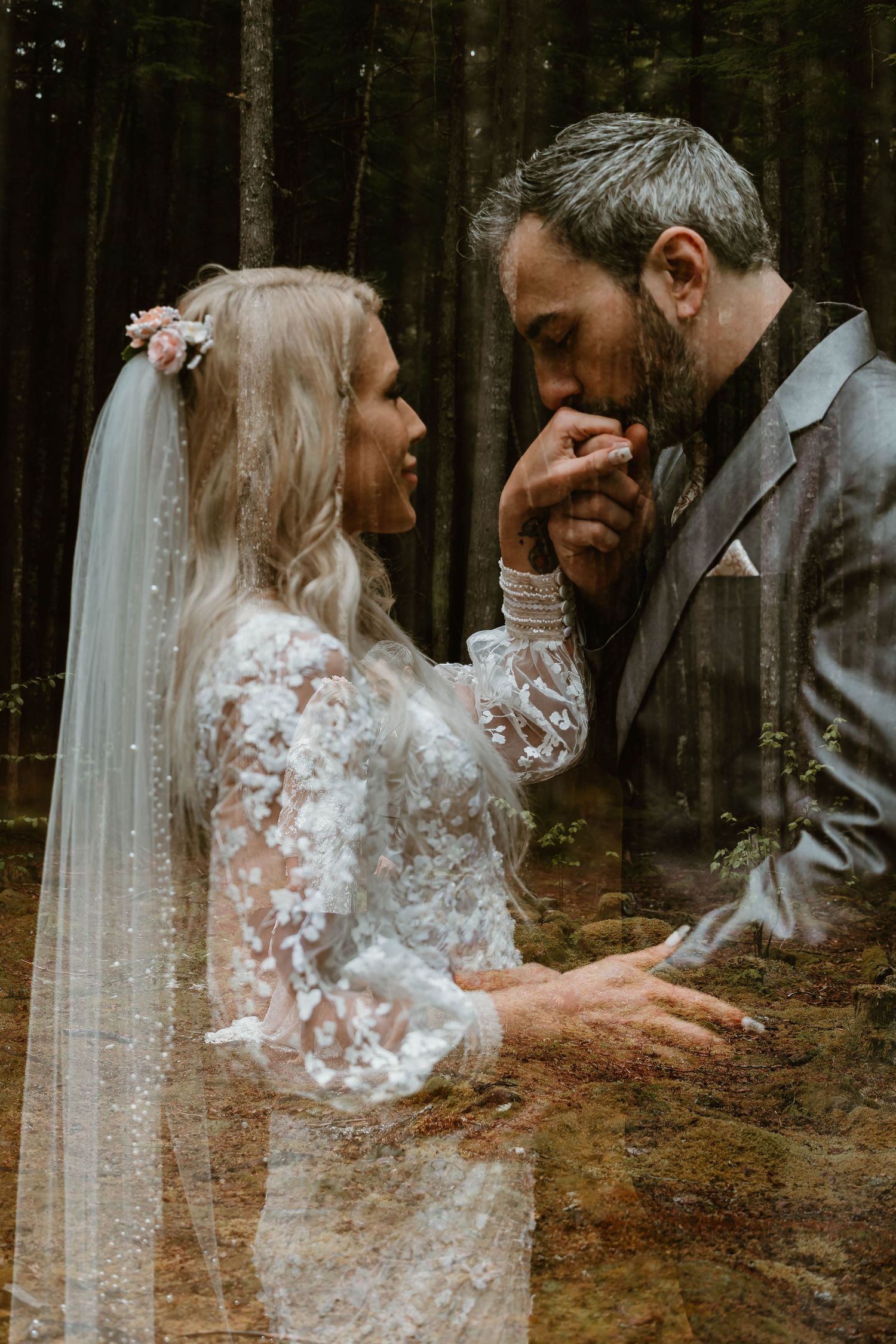 An intimate forest wedding scene with a couple sharing a romantic moment, the bride wearing a lace dress and veil.
