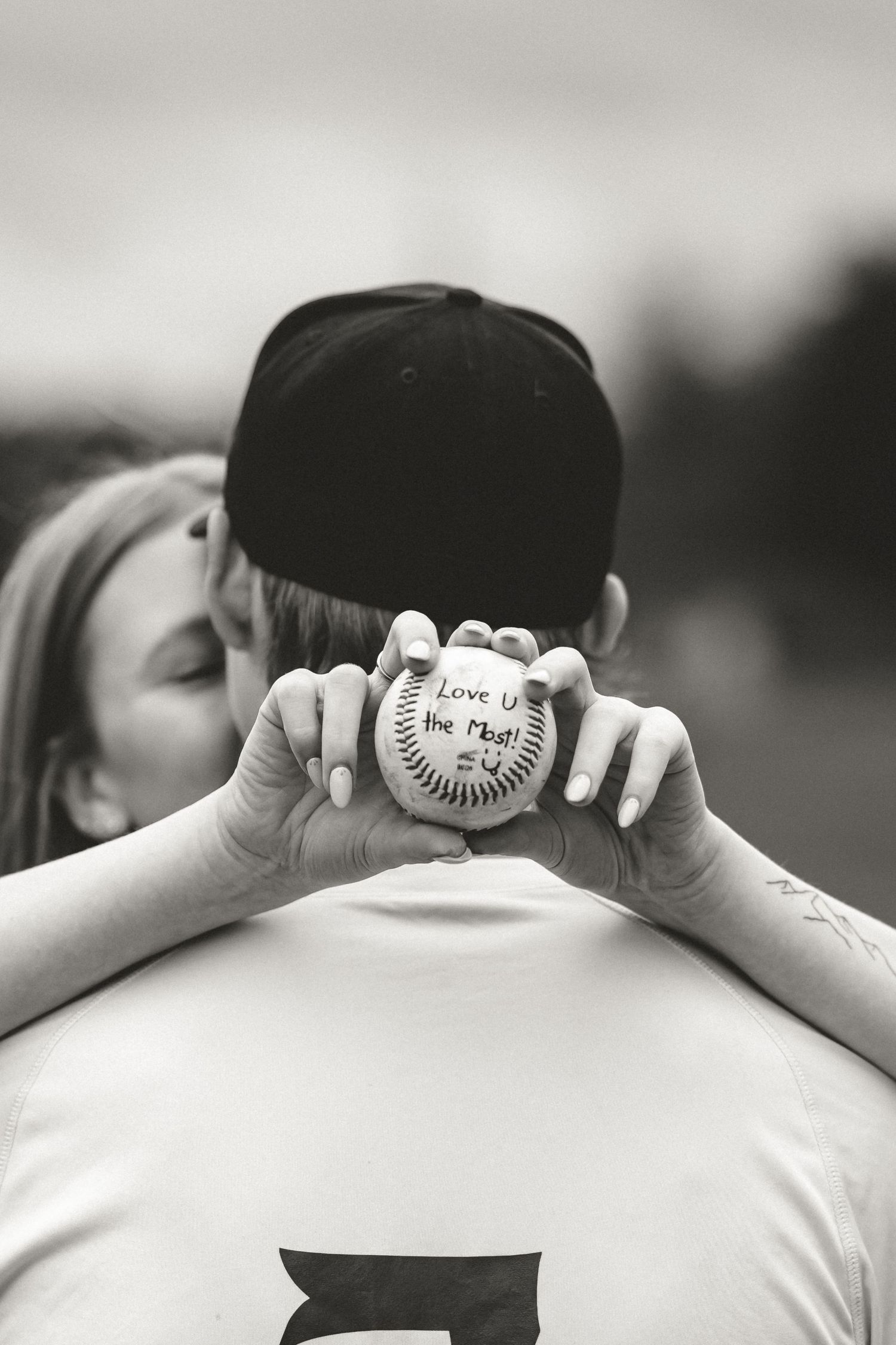 A black and white photo series shows a baseball being held up against someone's back in different angles.