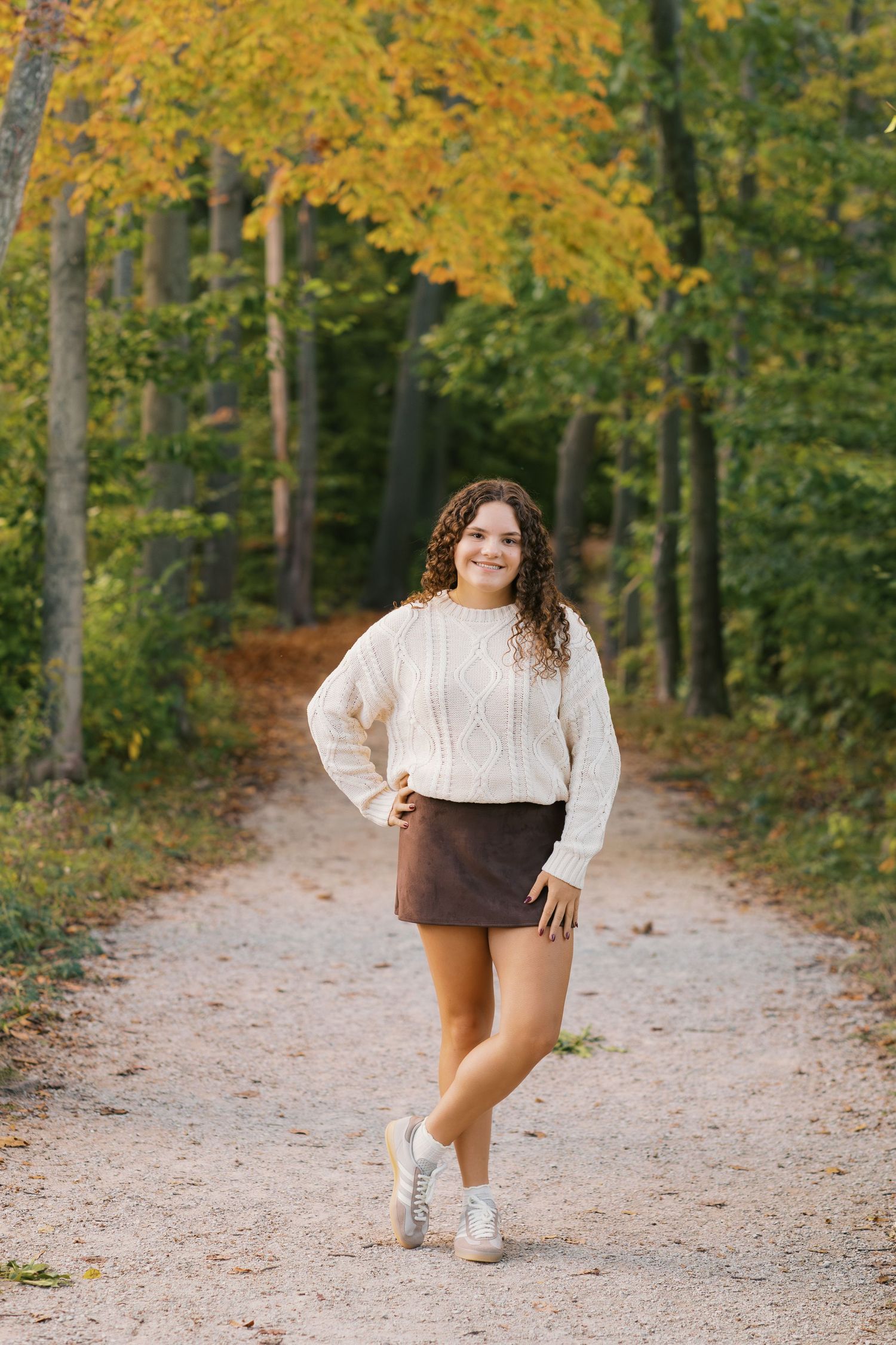 Senior Portrait Photography Hofma Preserve in Grand Haven Michigan. fall foliage forested area with a marshy boardwalk senior pictures