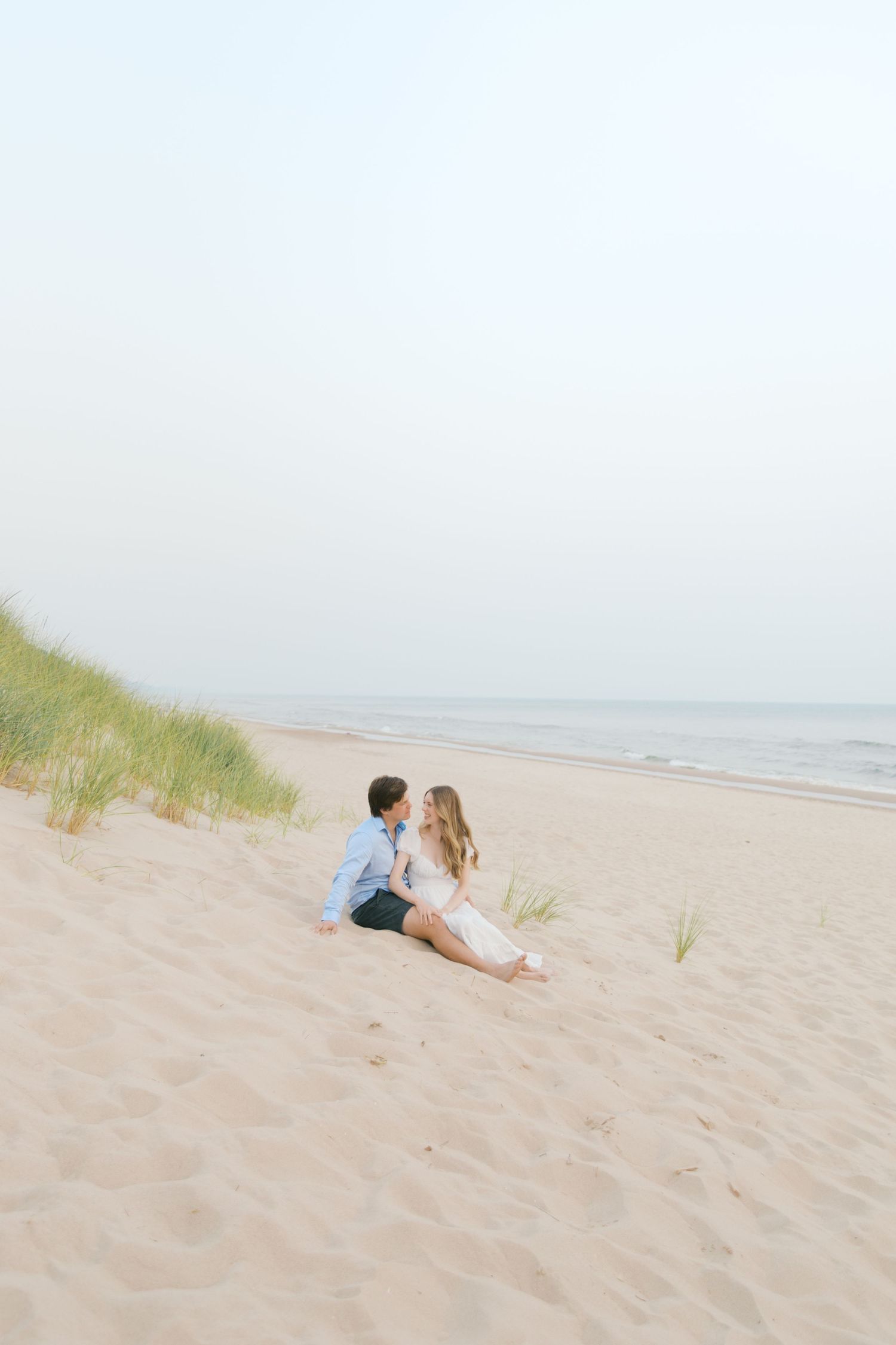 Grand Haven beach and boardwalk coastal midwest town on lake michigan engagement pictures during the summer Grand Haven Wedding photographer