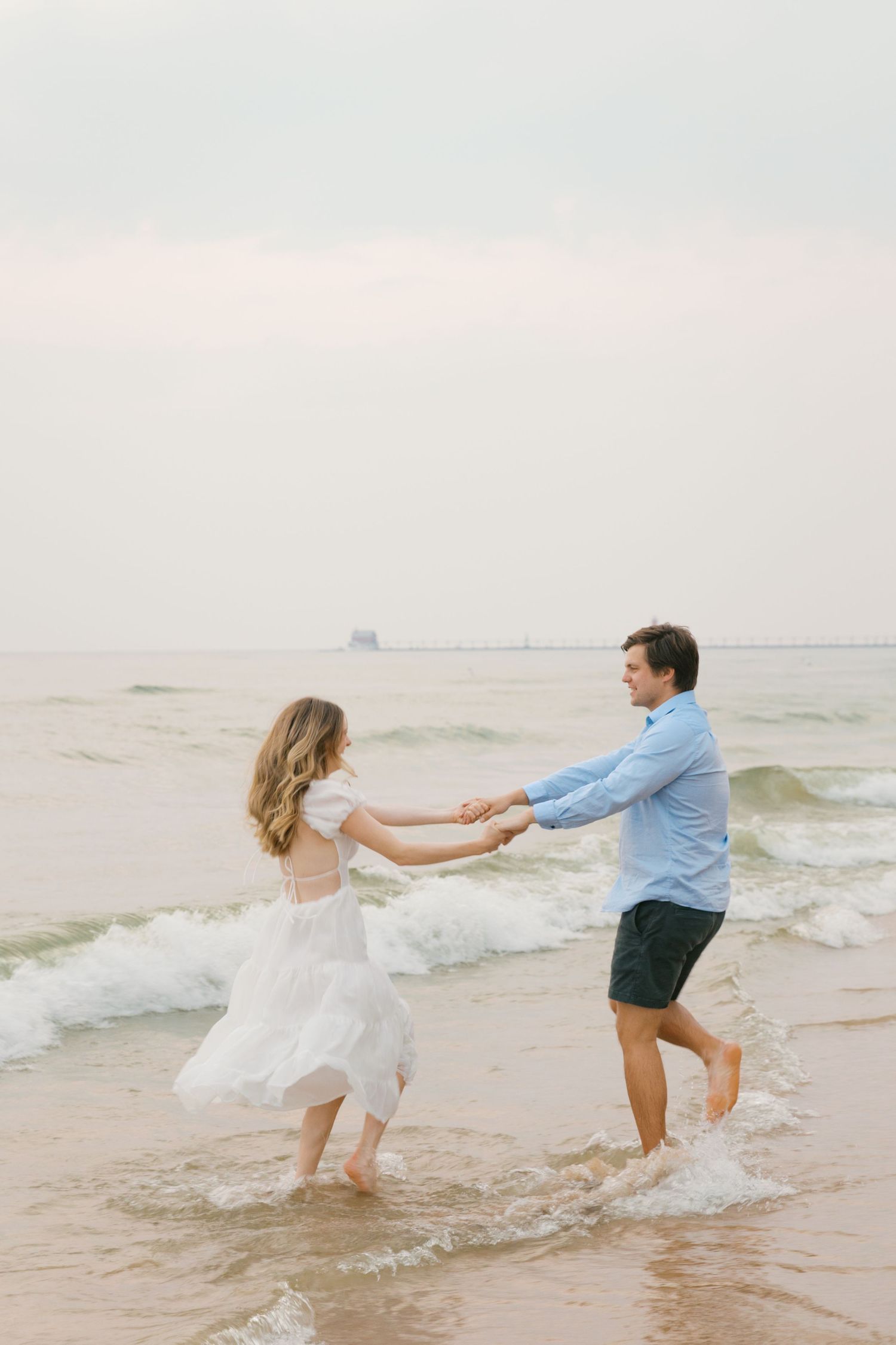 Grand Haven beach and boardwalk coastal midwest town on lake michigan engagement pictures during the summer Grand Haven Wedding photographer