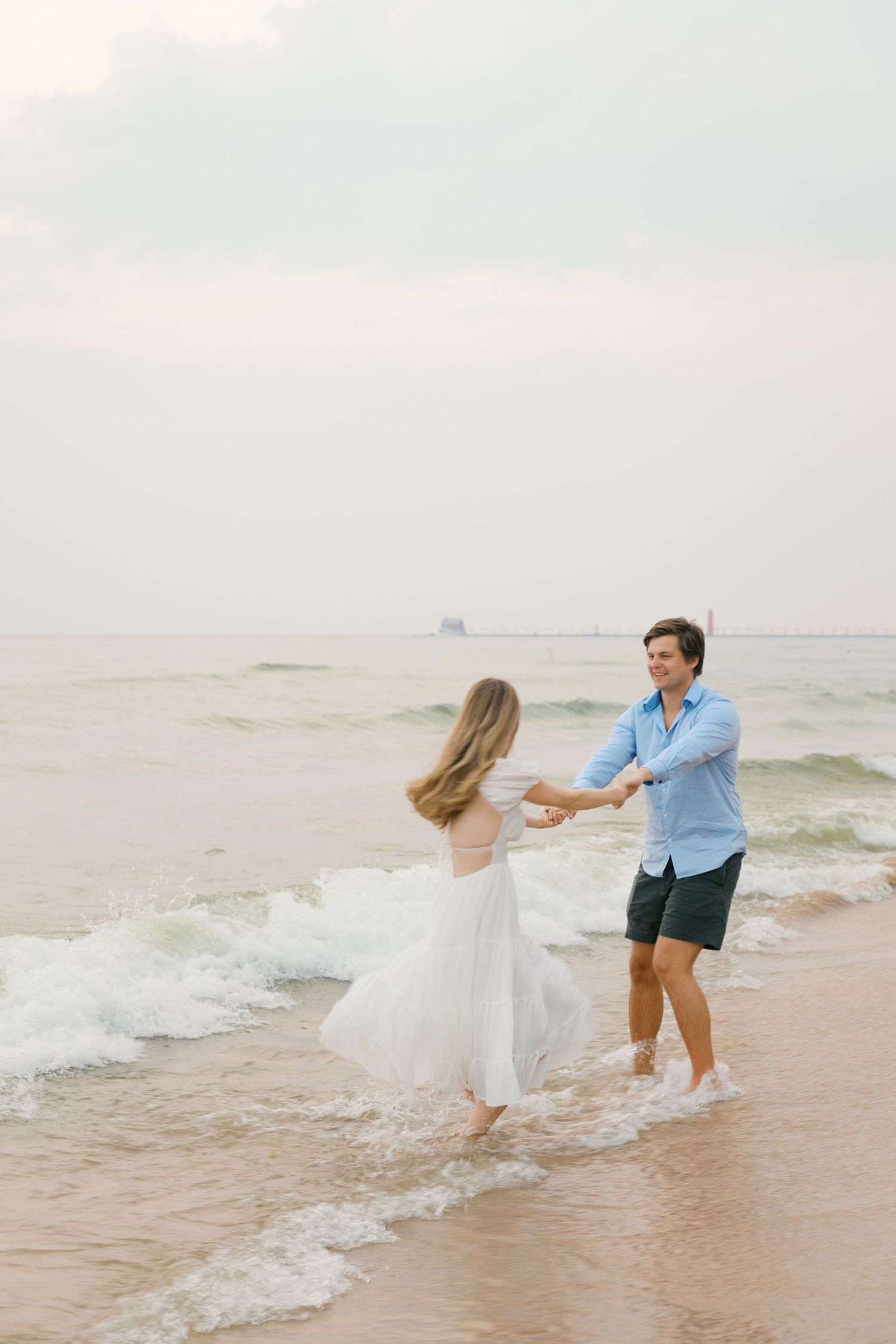 Grand Haven beach and boardwalk coastal midwest town on lake michigan engagement pictures during the summer Grand Haven Wedding photographer