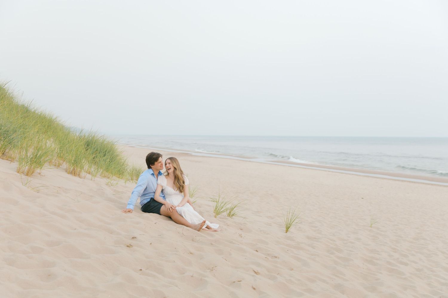 Grand Haven beach and boardwalk coastal midwest town on lake michigan engagement pictures during the summer Grand Haven Wedding photographer