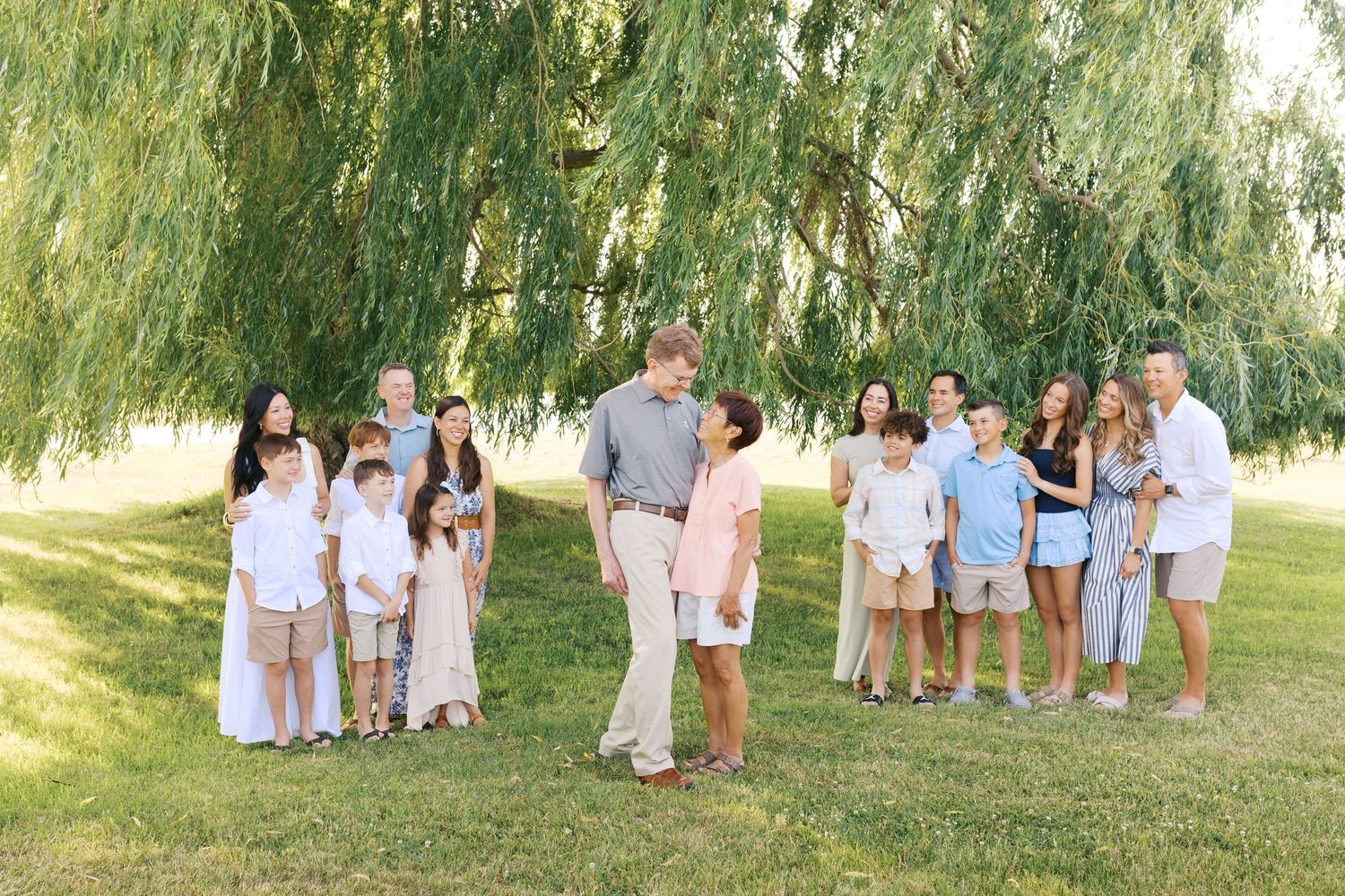 Extended family portrait photography session at harbor island grand haven michigan. Set in the spring with bright colors and willow trees.