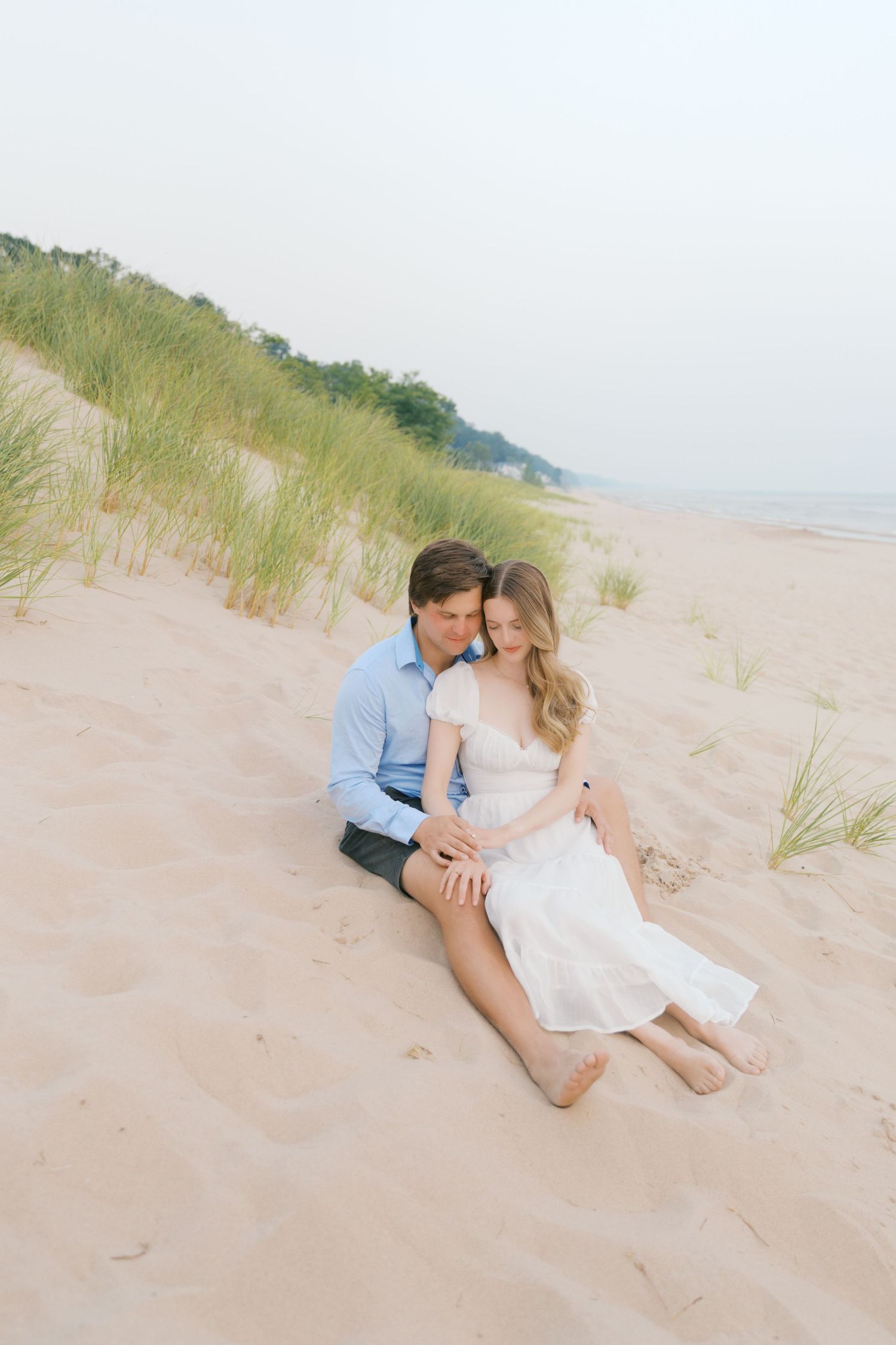 Grand Haven beach and boardwalk coastal midwest town on lake michigan engagement pictures during the summer Grand Haven Wedding photographer