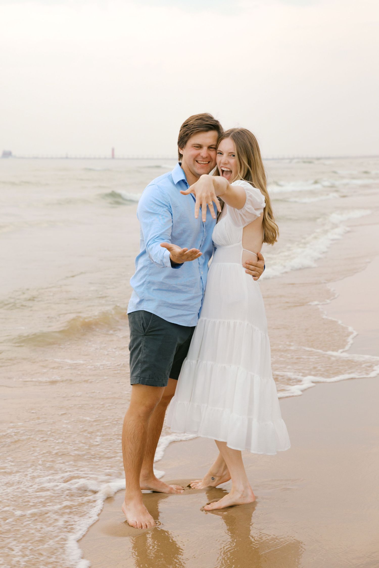 Grand Haven beach and boardwalk coastal midwest town on lake michigan engagement pictures during the summer Grand Haven Wedding photographer