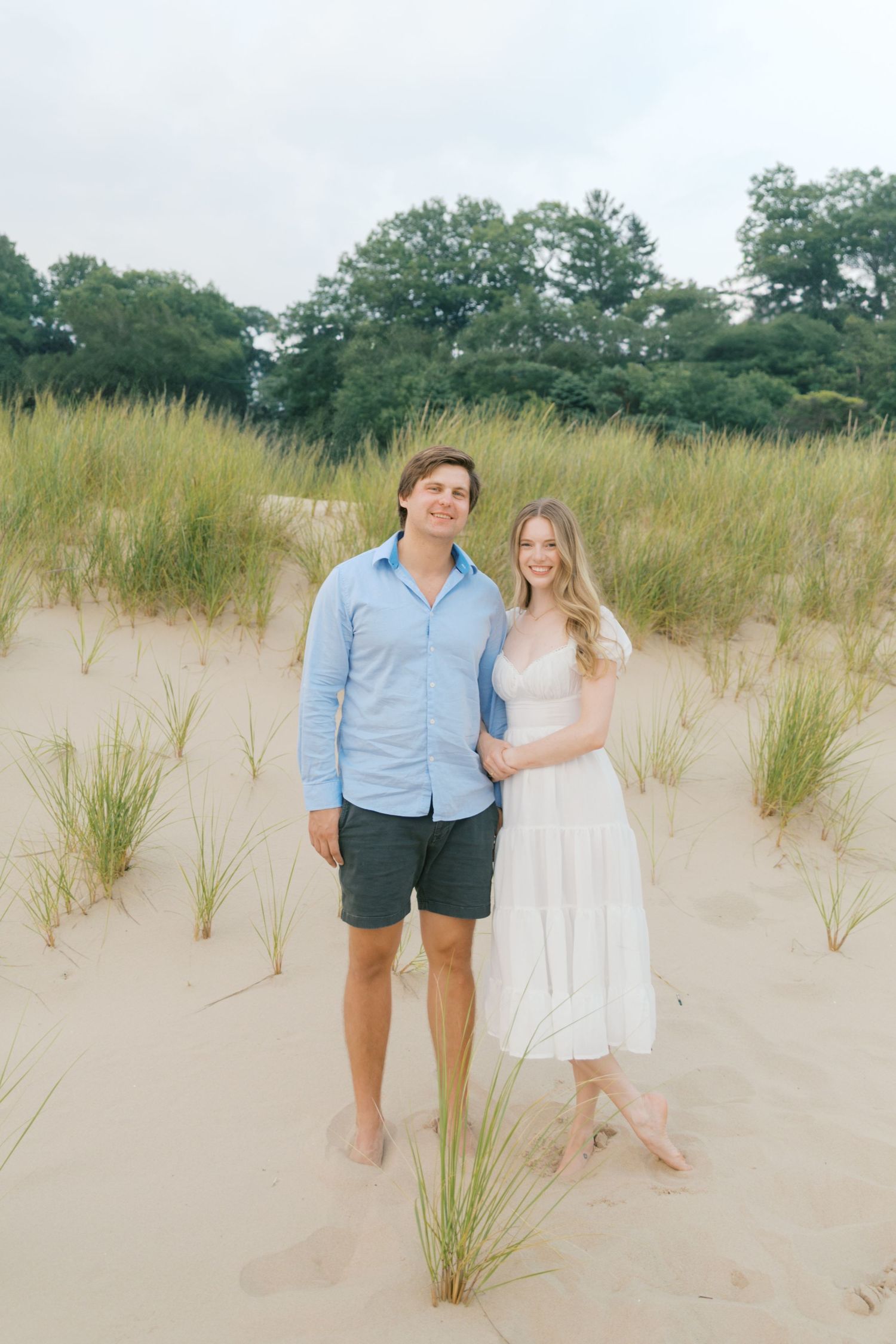 Grand Haven beach and boardwalk coastal midwest town on lake michigan engagement pictures during the summer Grand Haven Wedding photographer
