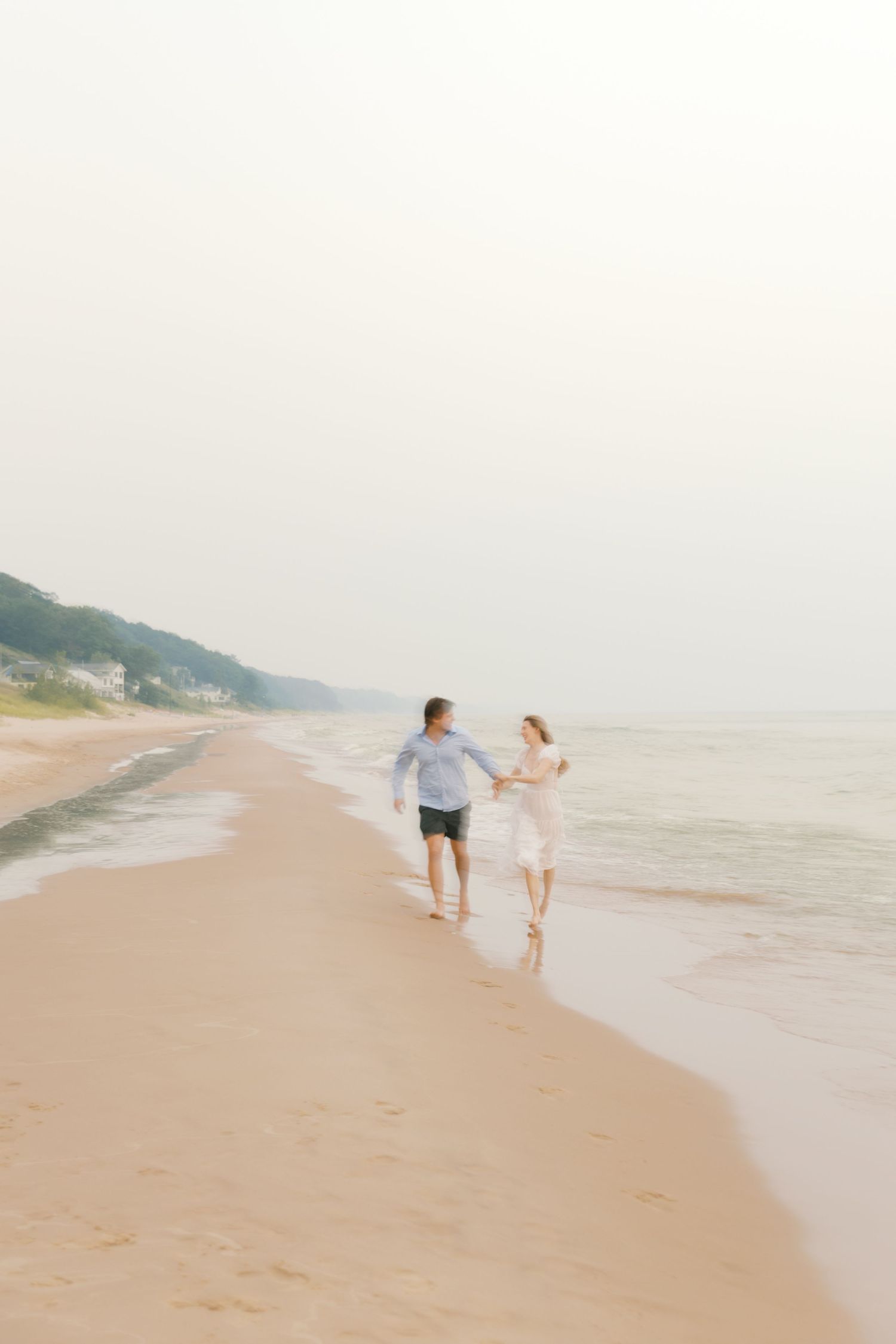 Grand Haven beach and boardwalk coastal midwest town on lake michigan engagement pictures during the summer Grand Haven Wedding photographer