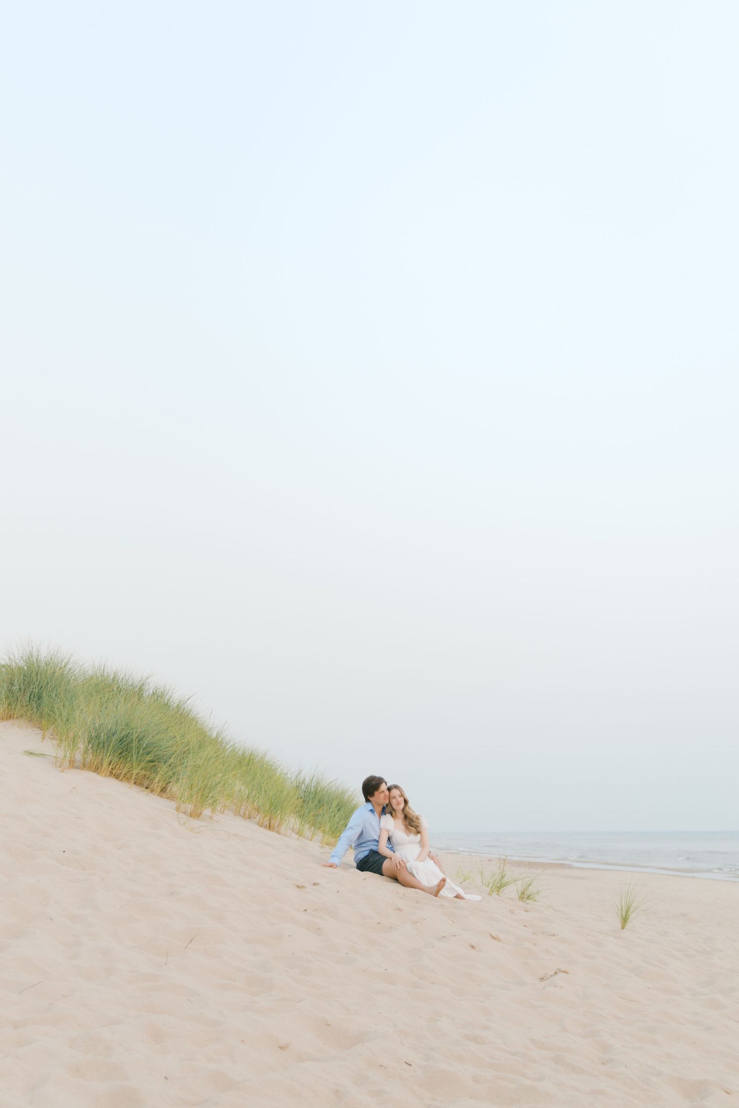 Grand Haven beach and boardwalk coastal midwest town on lake michigan engagement pictures during the summer Grand Haven Wedding photographer