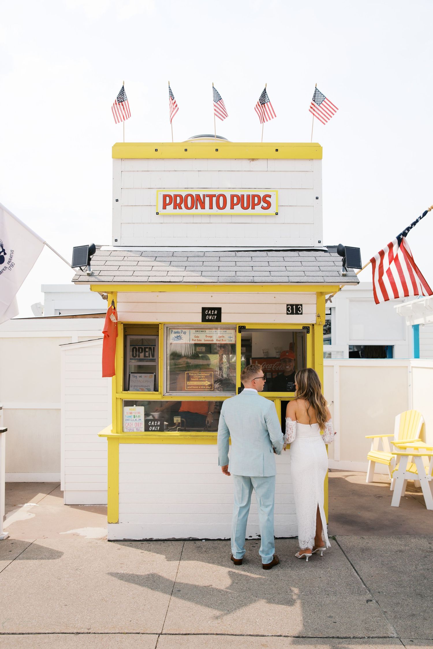 Grand Haven Michigan Elopement Photography at Pronto Pups corndog stand on Harbor Dr. Coastal summer elopement. From, Rayna Photography