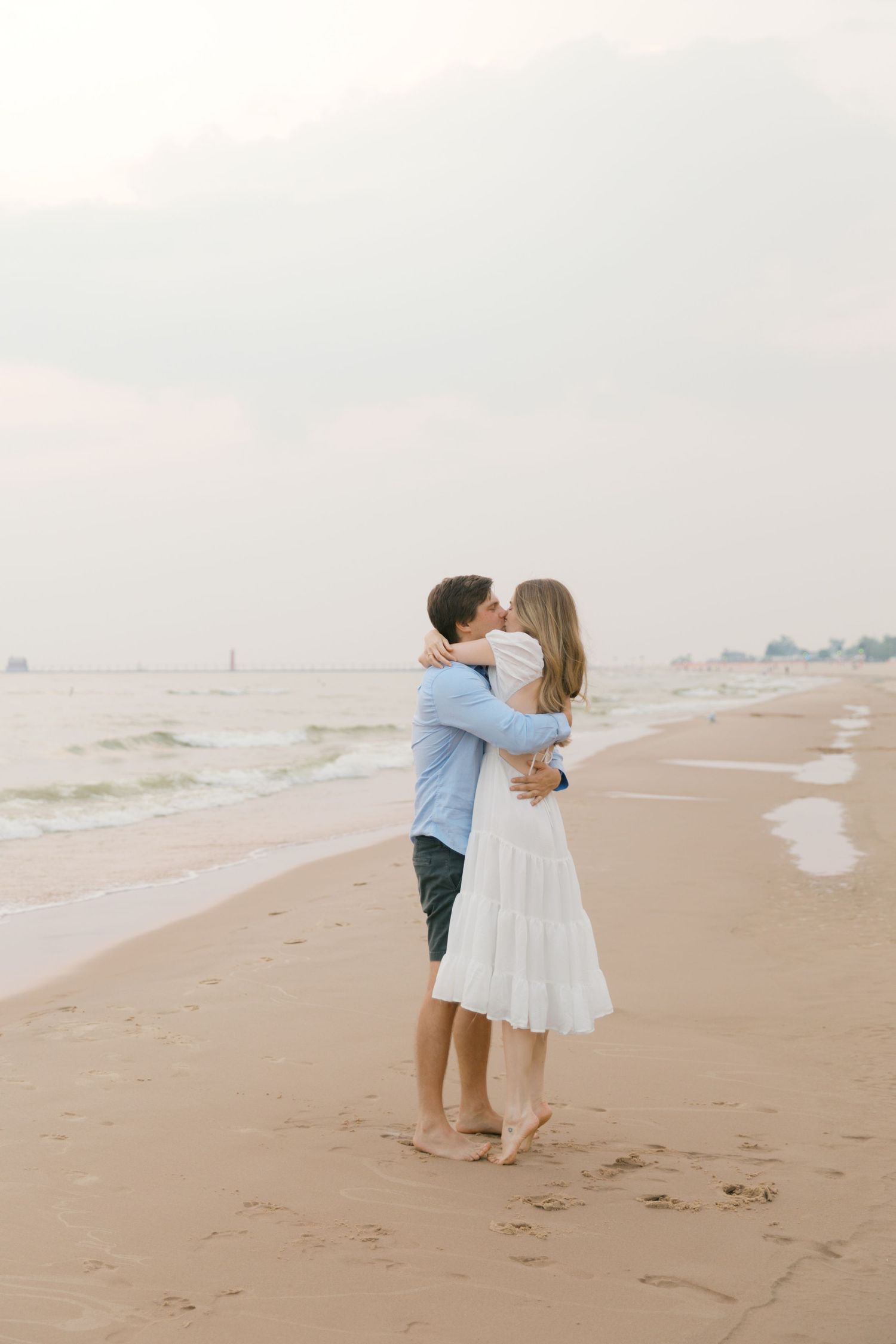 Grand Haven beach and boardwalk coastal midwest town on lake michigan engagement pictures during the summer Grand Haven Wedding photographer