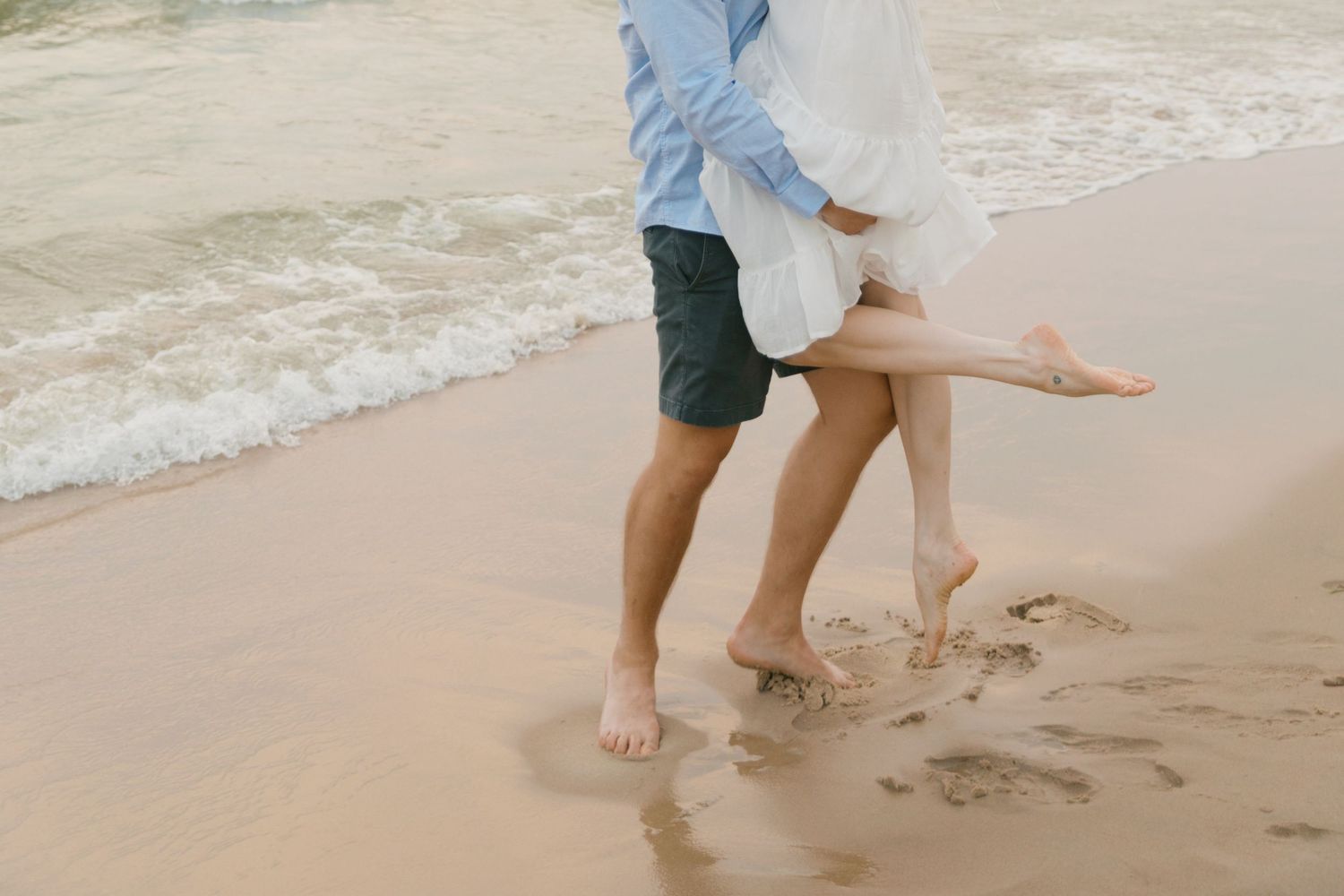Grand Haven beach and boardwalk coastal midwest town on lake michigan engagement pictures during the summer Grand Haven Wedding photographer