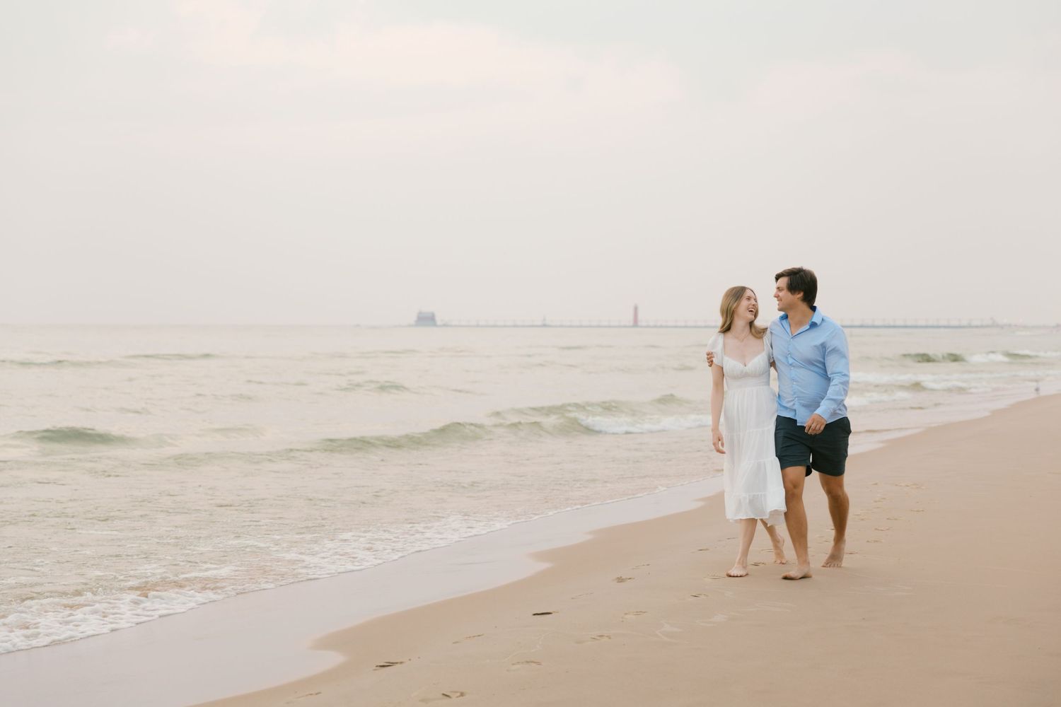 Grand Haven beach and boardwalk coastal midwest town on lake michigan engagement pictures during the summer Grand Haven Wedding photographer