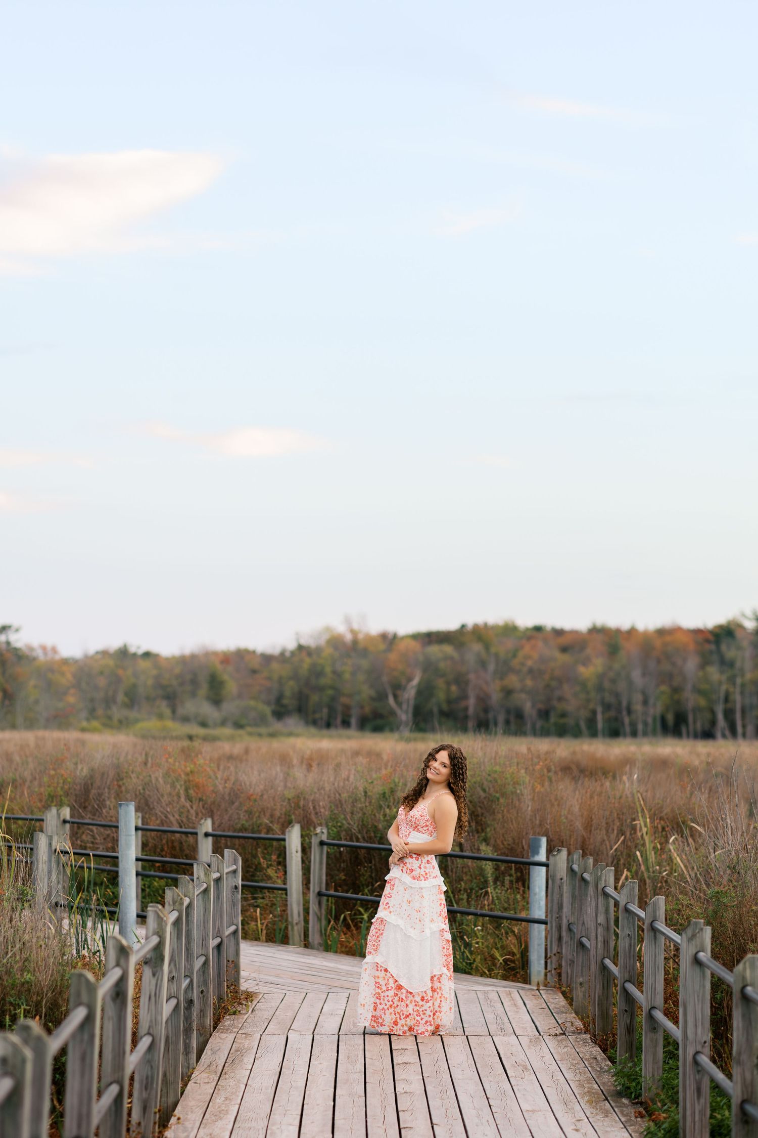 Senior Portrait Photography Hofma Preserve in Grand Haven Michigan. fall foliage forested area with a marshy boardwalk senior pictures