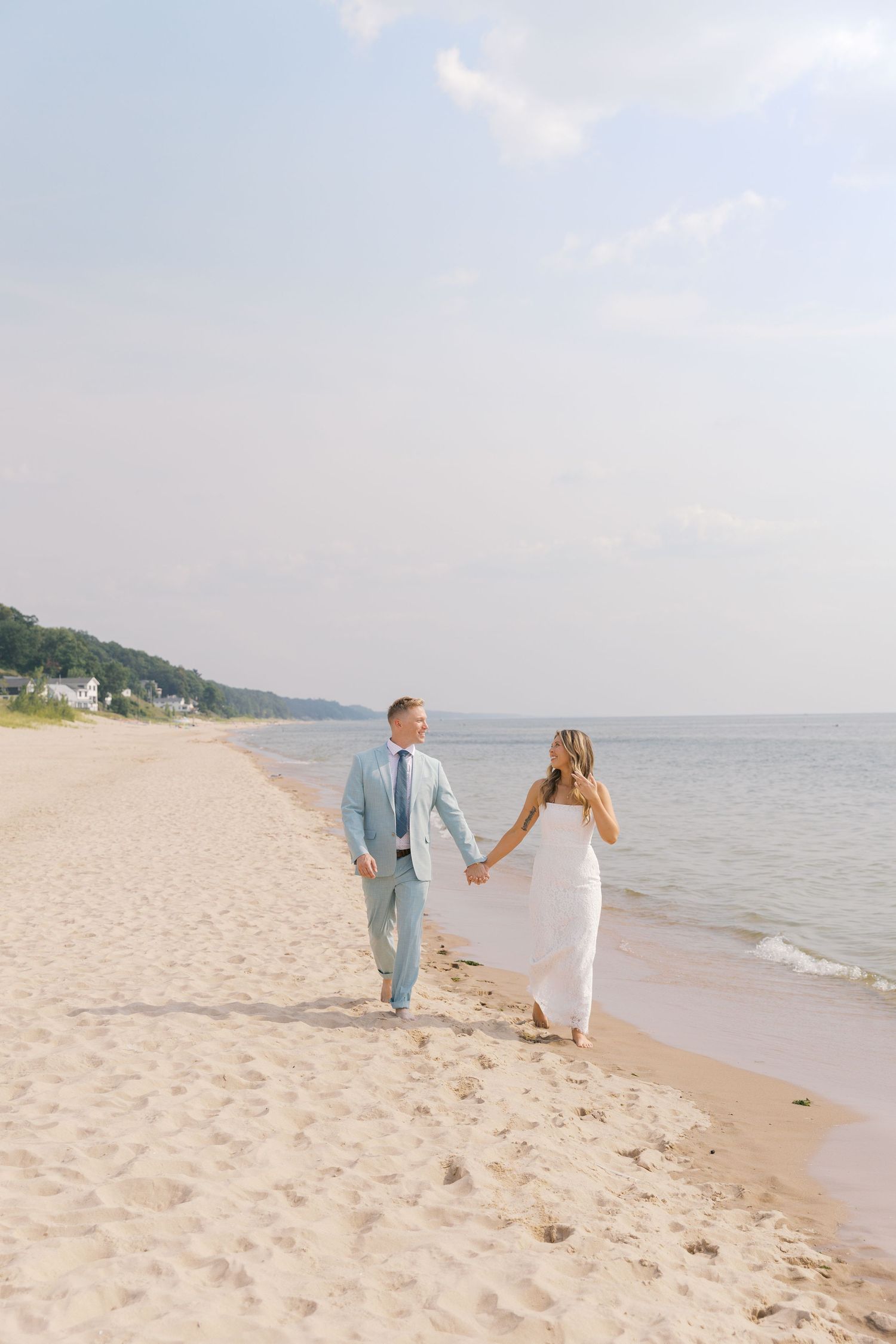 Grand Haven Michigan Elopement Photography at Grand Haven City Beach on Lake Michigan. Coastal summer elopement. From, Rayna Photography