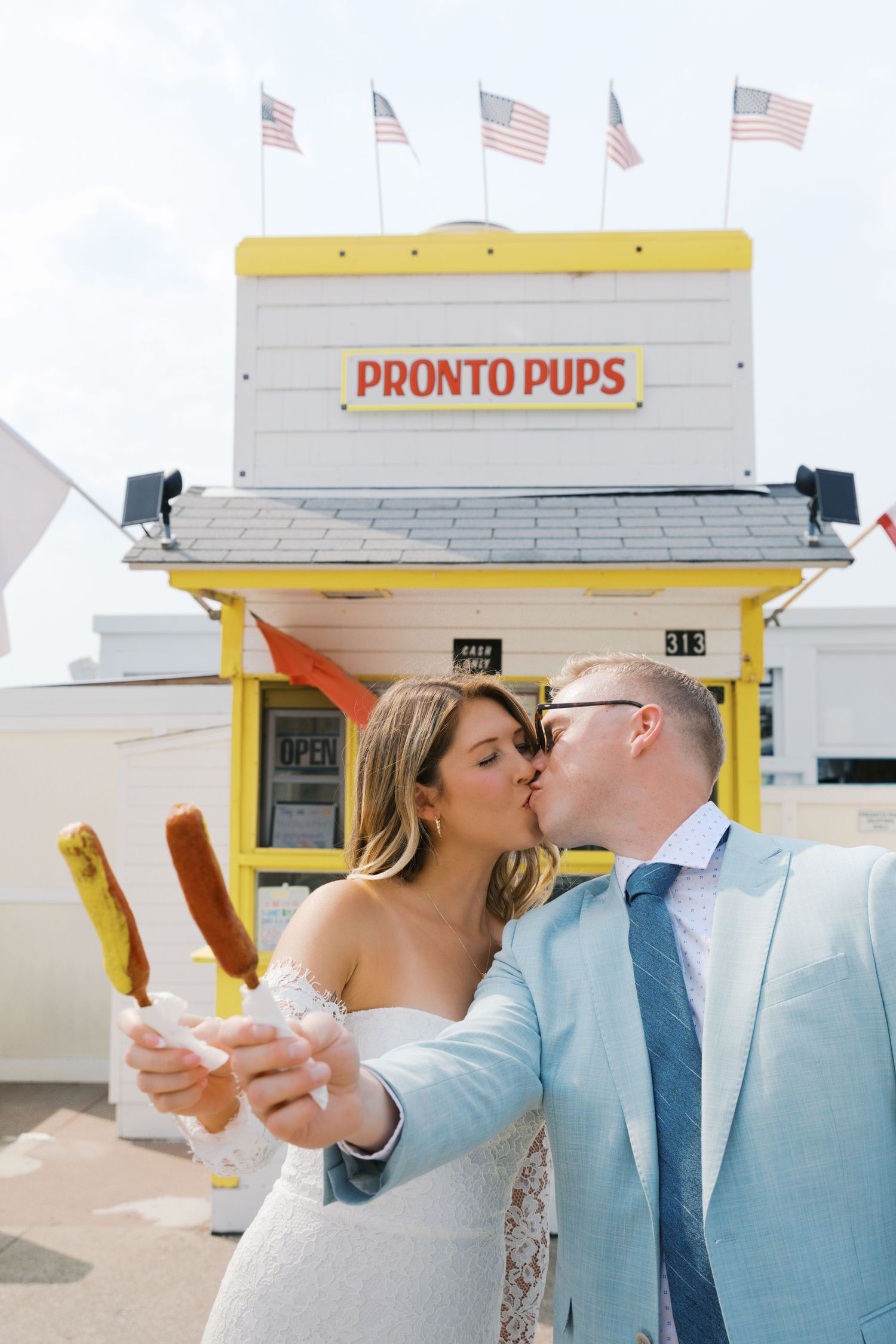 Grand Haven Michigan Elopement Photography at Pronto Pups corndog stand on Harbor Dr. Coastal summer elopement. From, Rayna Photography