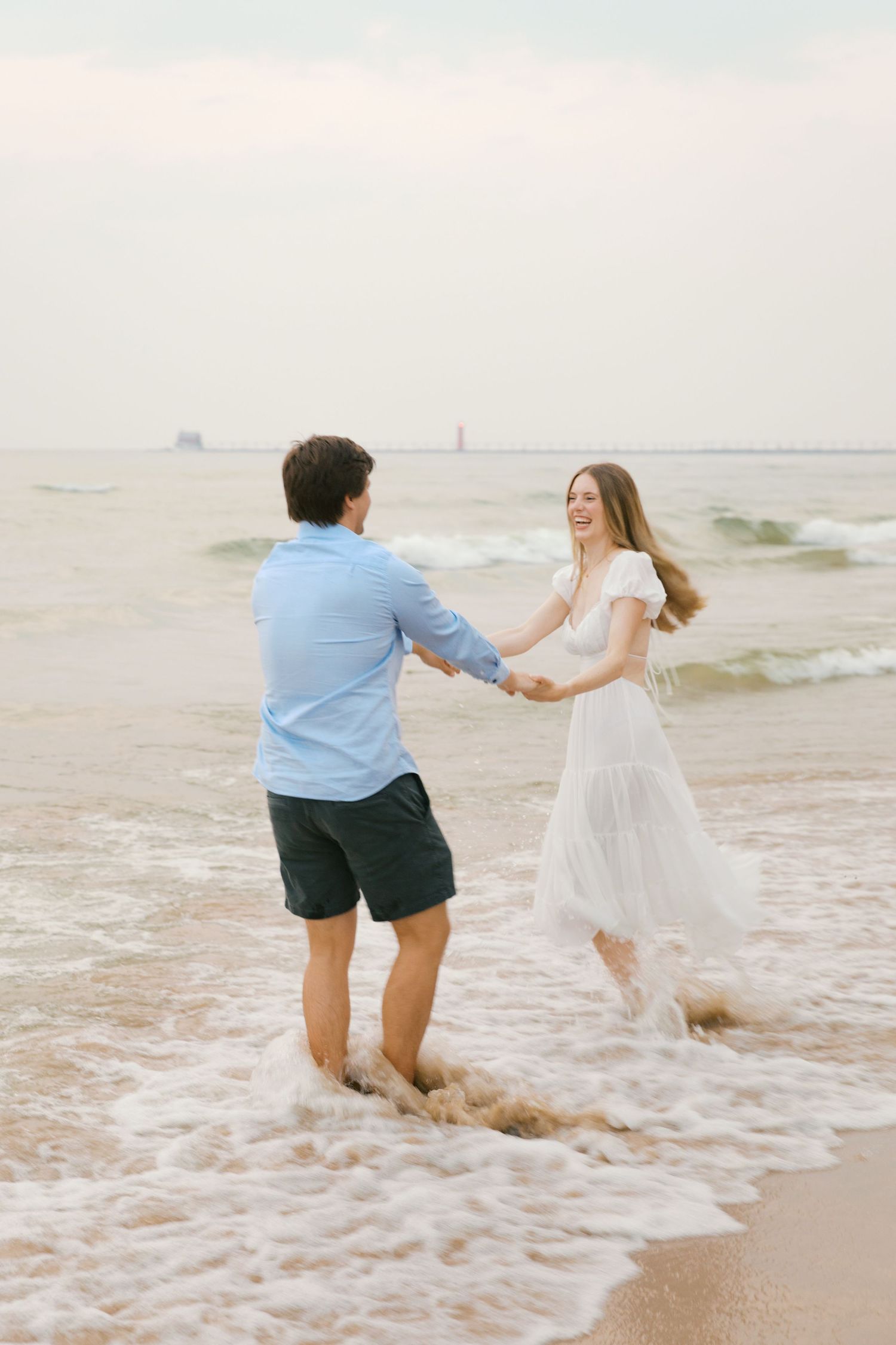 Grand Haven beach and boardwalk coastal midwest town on lake michigan engagement pictures during the summer Grand Haven Wedding photographer