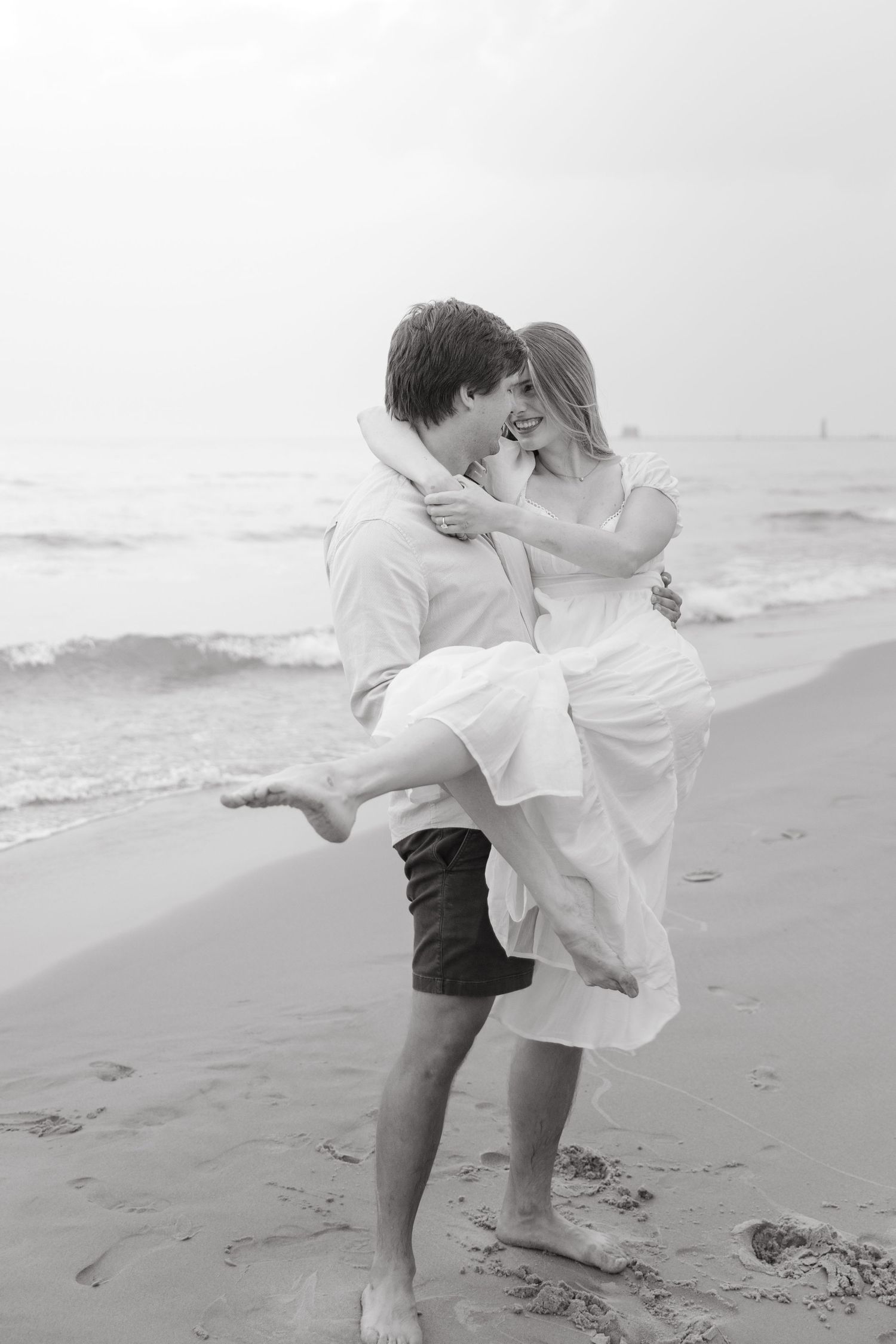 Grand Haven beach and boardwalk coastal midwest town on lake michigan engagement pictures during the summer Grand Haven Wedding photographer