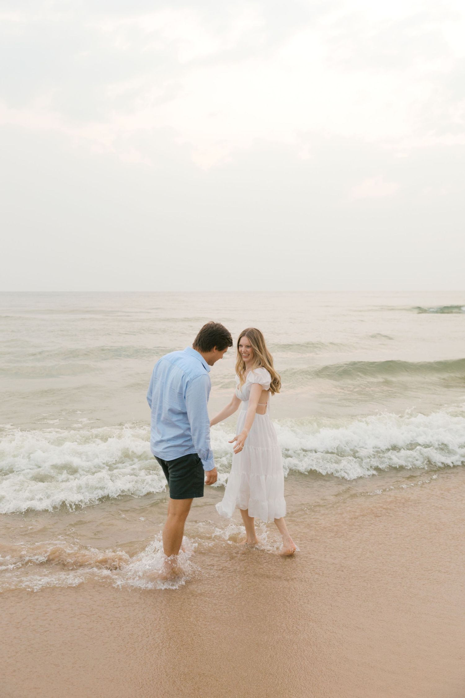 Grand Haven beach and boardwalk coastal midwest town on lake michigan engagement pictures during the summer Grand Haven Wedding photographer