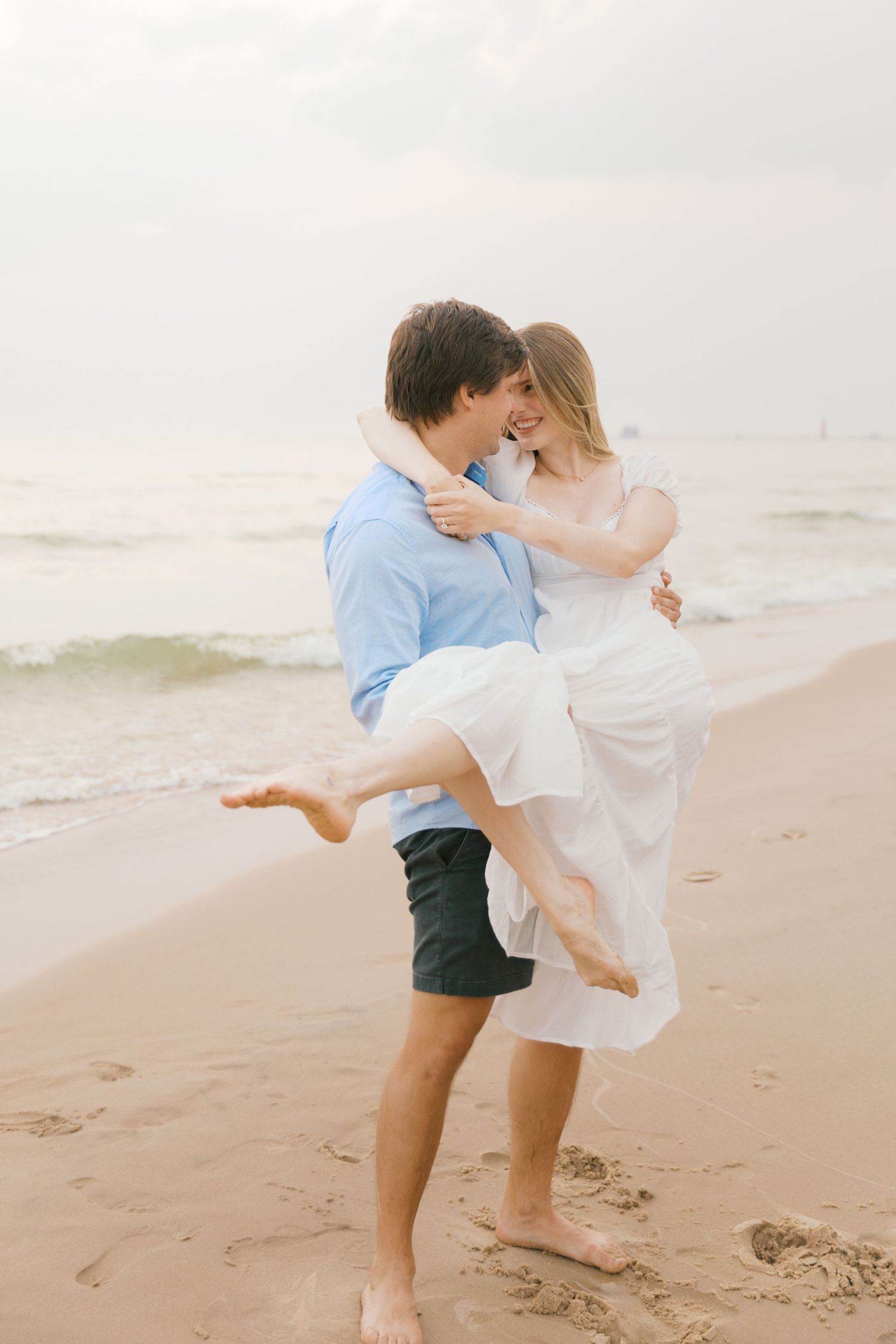 Grand Haven beach and boardwalk coastal midwest town on lake michigan engagement pictures during the summer Grand Haven Wedding photographer