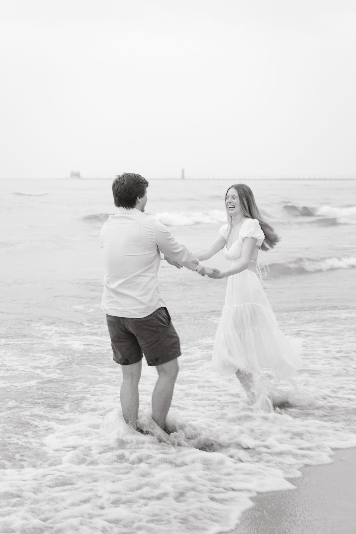 Grand Haven beach and boardwalk coastal midwest town on lake michigan engagement pictures during the summer Grand Haven Wedding photographer