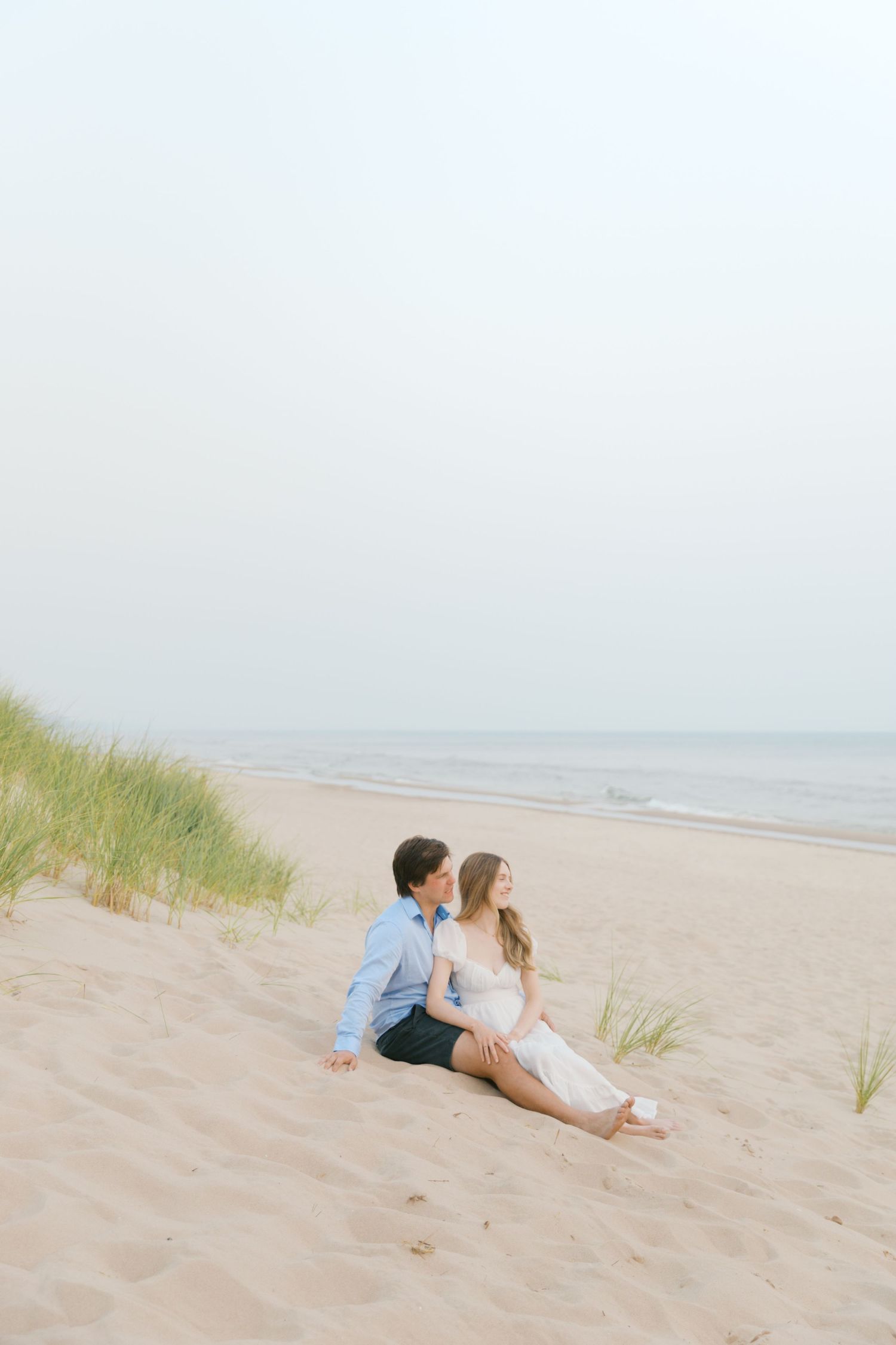 Grand Haven beach and boardwalk coastal midwest town on lake michigan engagement pictures during the summer Grand Haven Wedding photographer