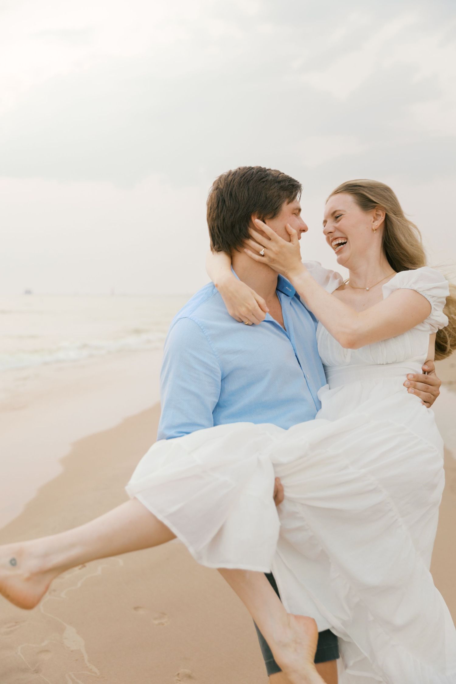 Grand Haven beach and boardwalk coastal midwest town on lake michigan engagement pictures during the summer Grand Haven Wedding photographer