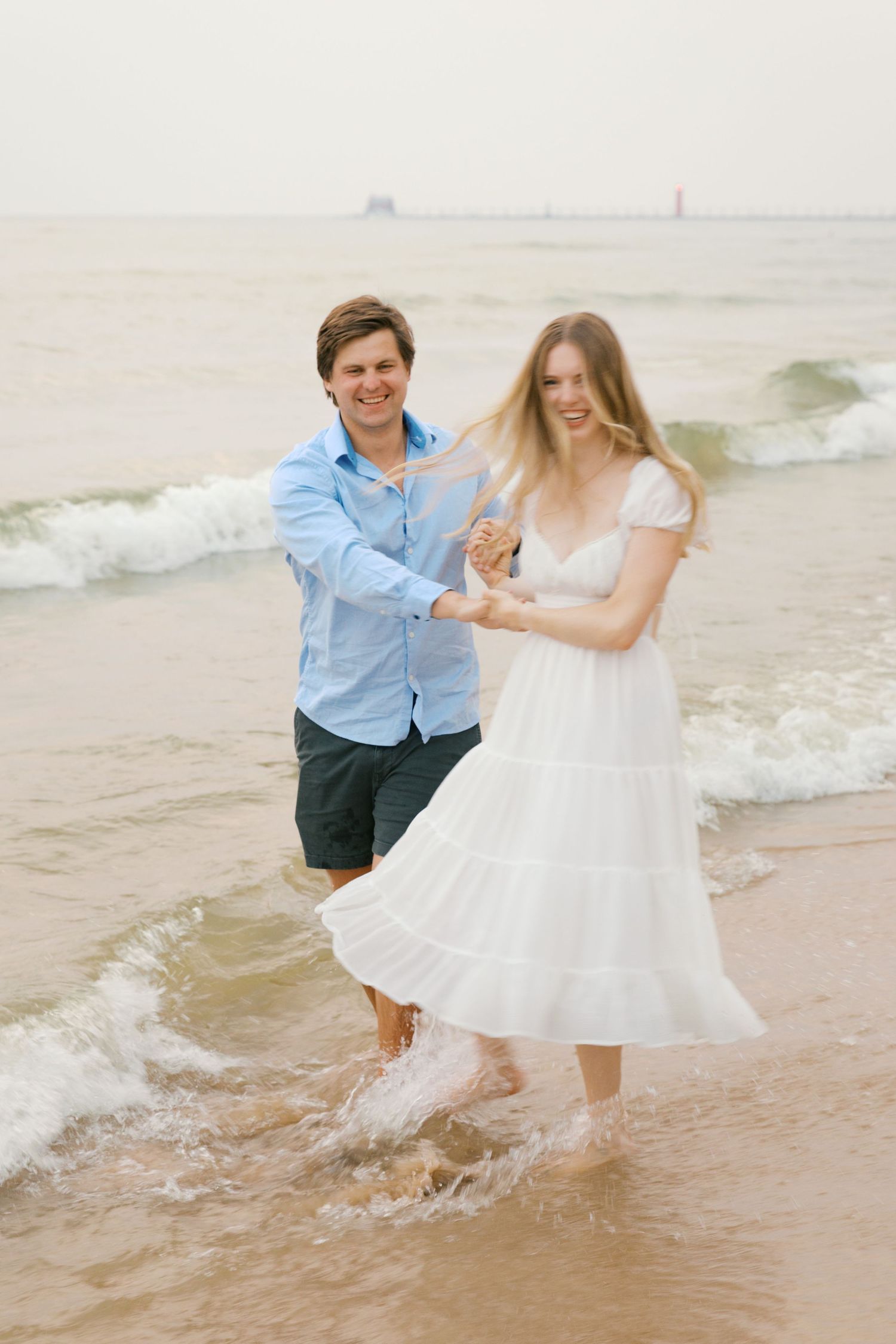 Grand Haven beach and boardwalk coastal midwest town on lake michigan engagement pictures during the summer Grand Haven Wedding photographer