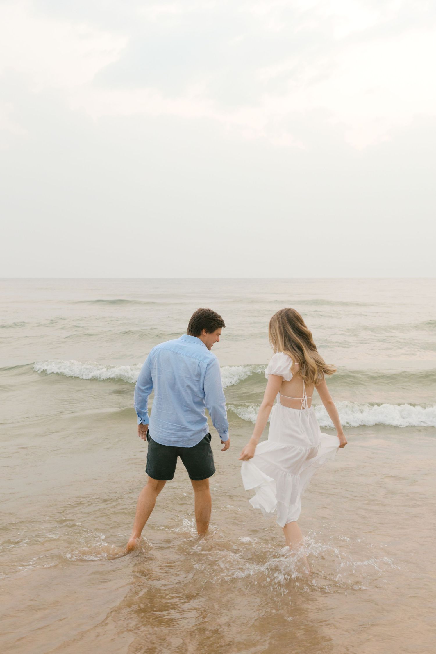 Grand Haven beach and boardwalk coastal midwest town on lake michigan engagement pictures during the summer Grand Haven Wedding photographer