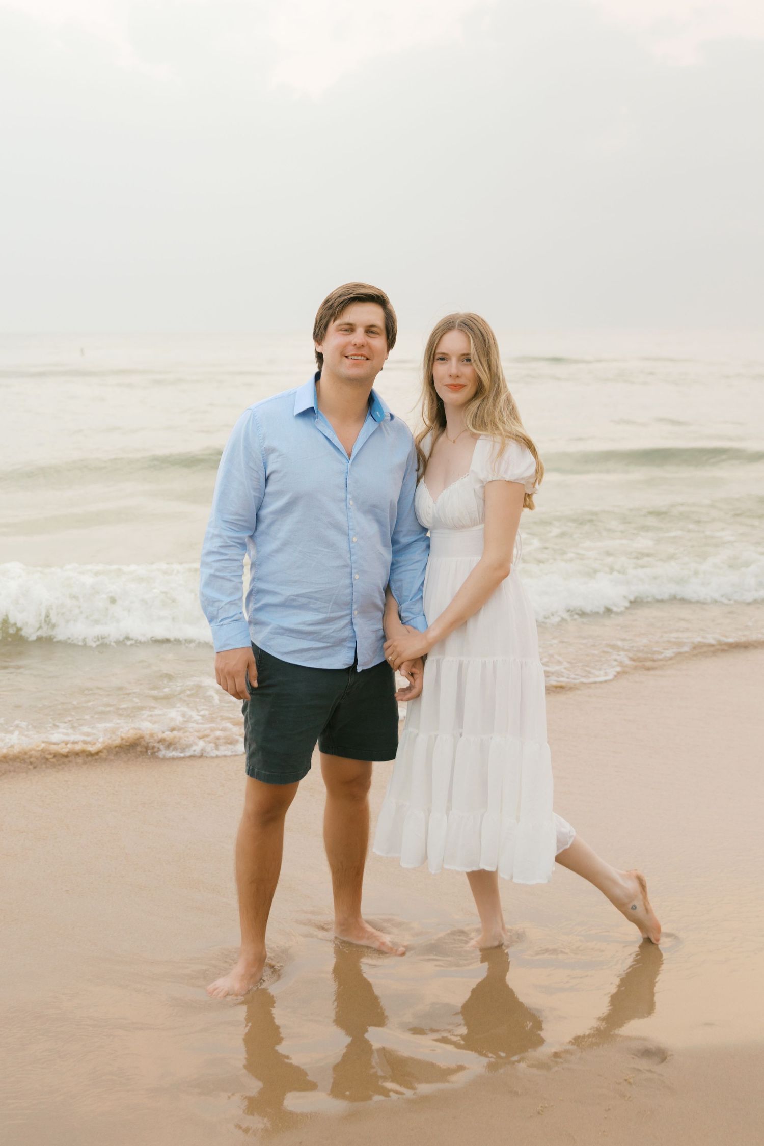 Grand Haven beach and boardwalk coastal midwest town on lake michigan engagement pictures during the summer Grand Haven Wedding photographer
