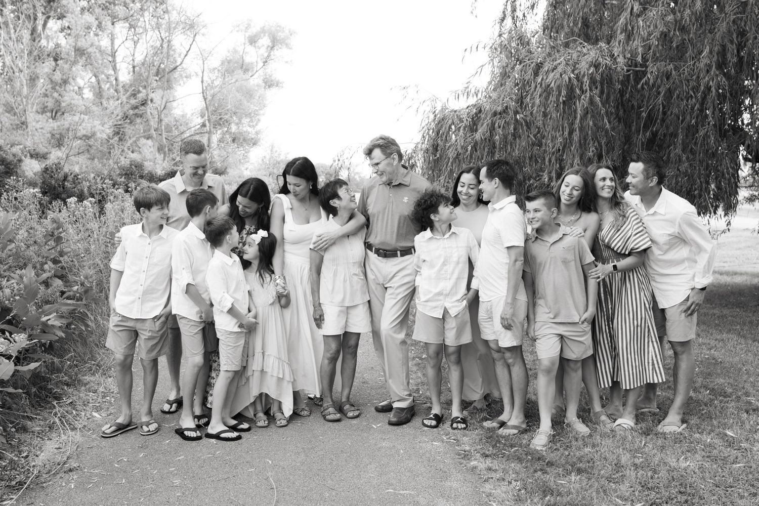 Extended family portrait photography session at harbor island grand haven michigan. Set in the spring with bright colors and willow trees.