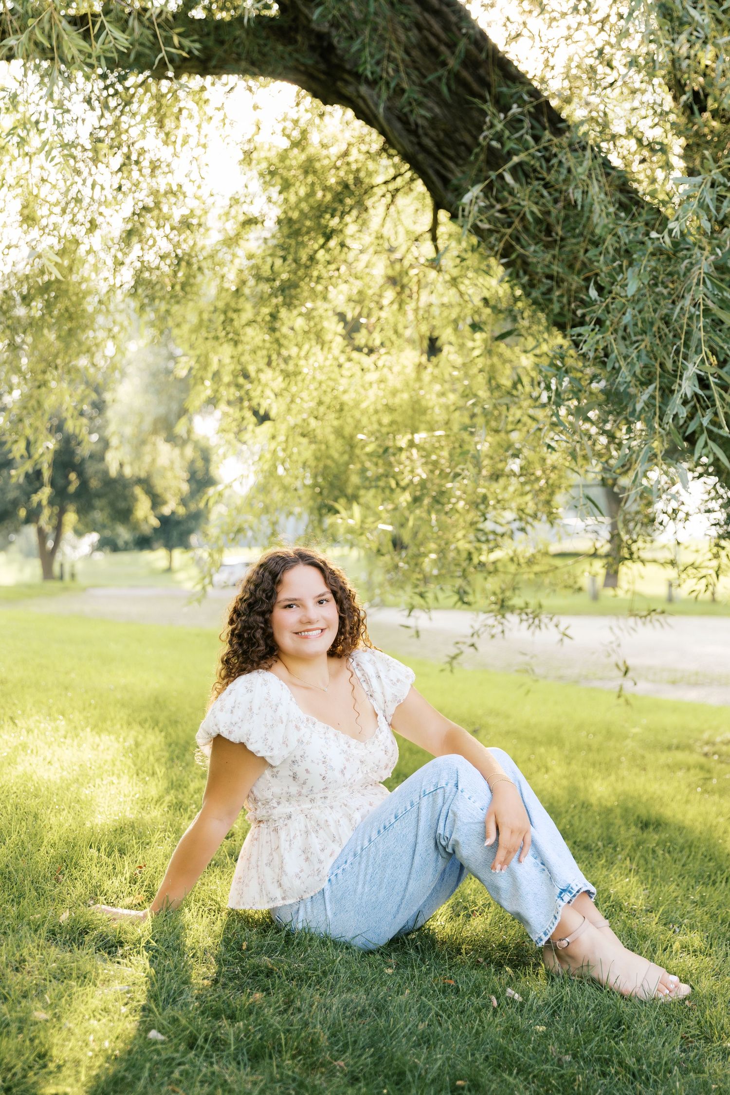 Senior Portrait Photography Pictures at East Grand River Park in Grand Haven Michigan. Dock and lakeside senior pictures under a willow tree