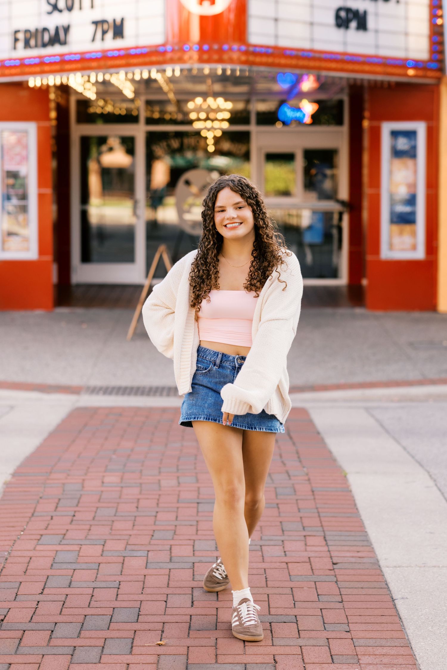 Senior Portrait Photography Pictures in downtown Grand Haven Michigan on washington street with the marquee sign