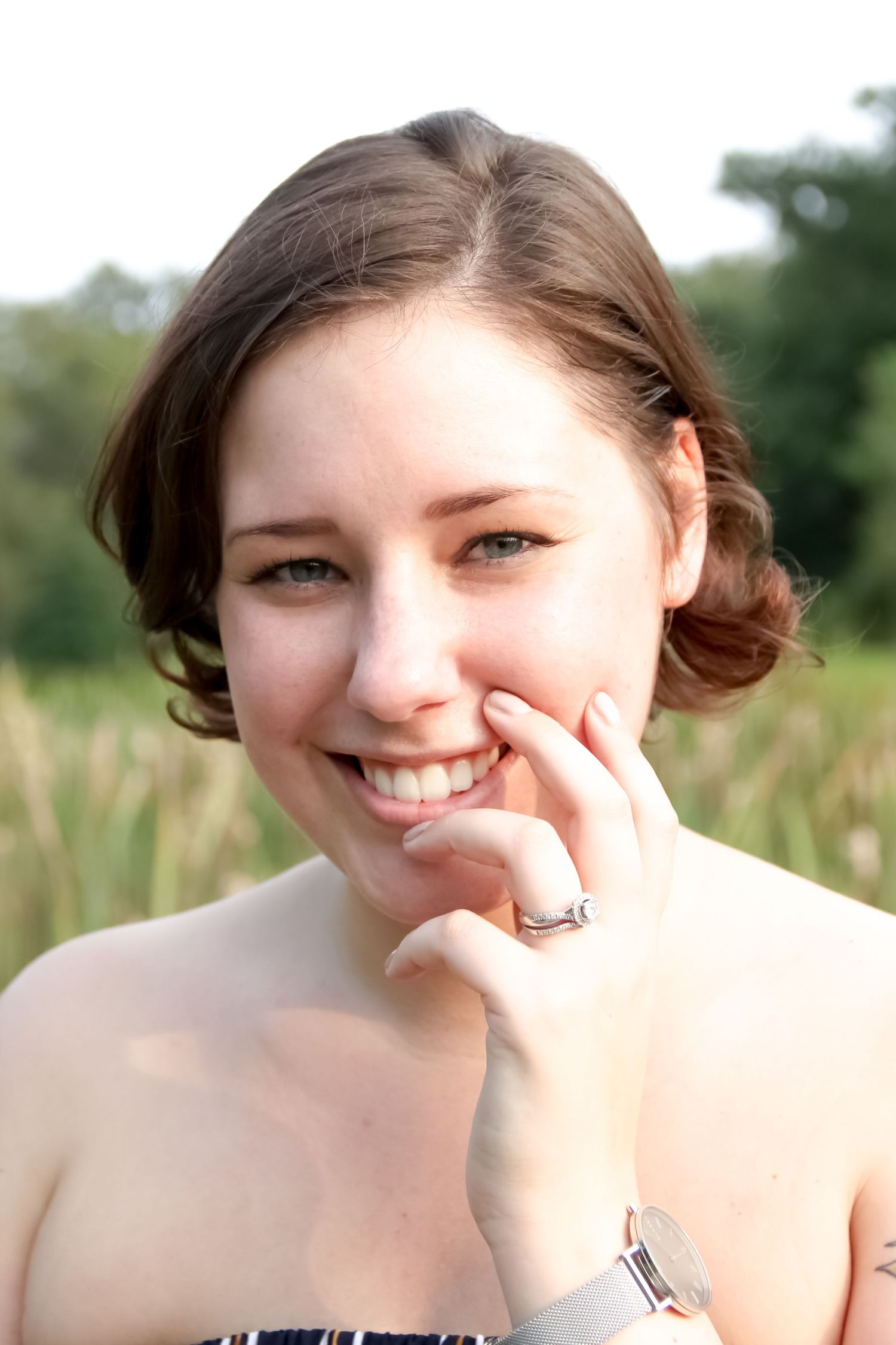 Outdoor portrait in natural setting wearing strapless dress.