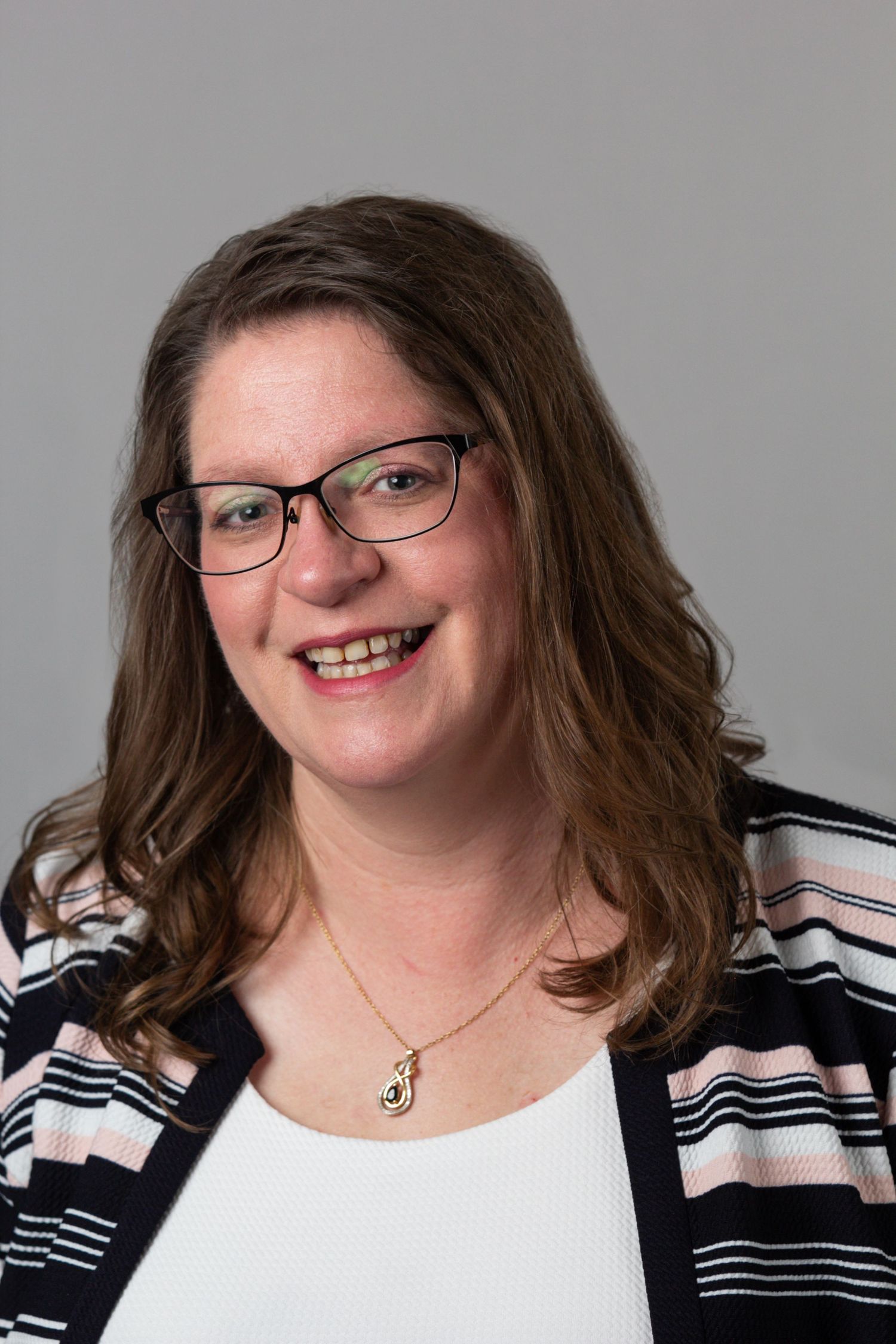 A series of cropped portraits showing someone wearing glasses and a black and white striped cardigan over a white top.