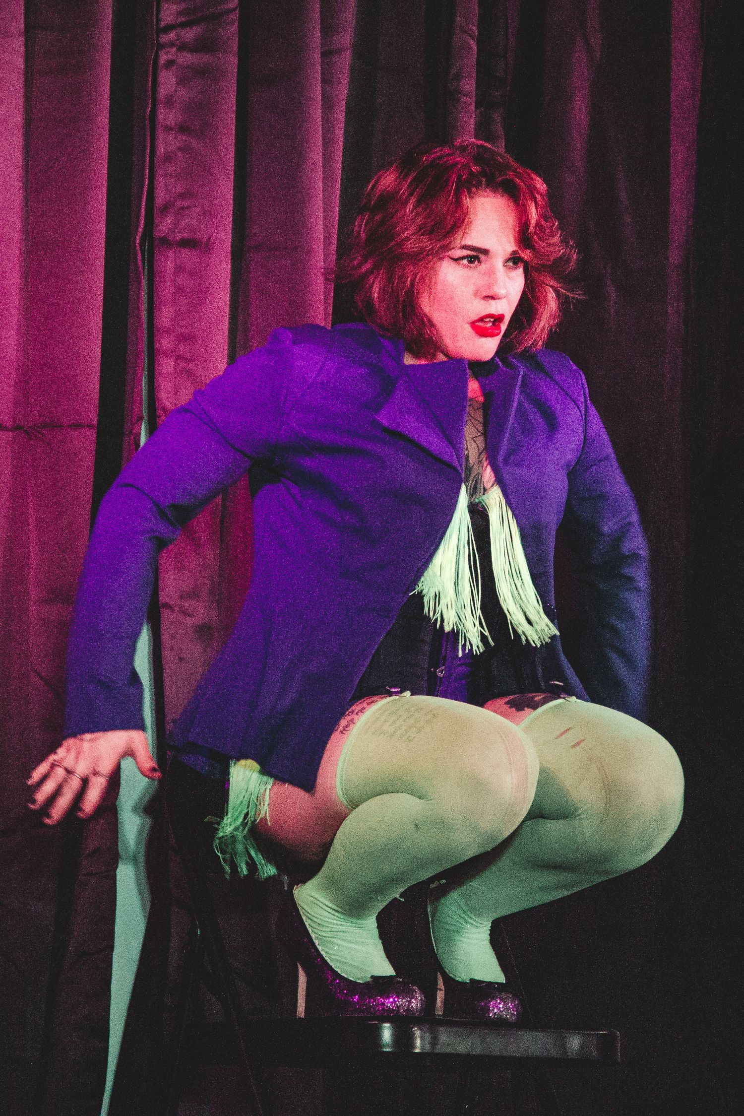 A performance sequence showing a dancer in green pants against purple stage curtains.