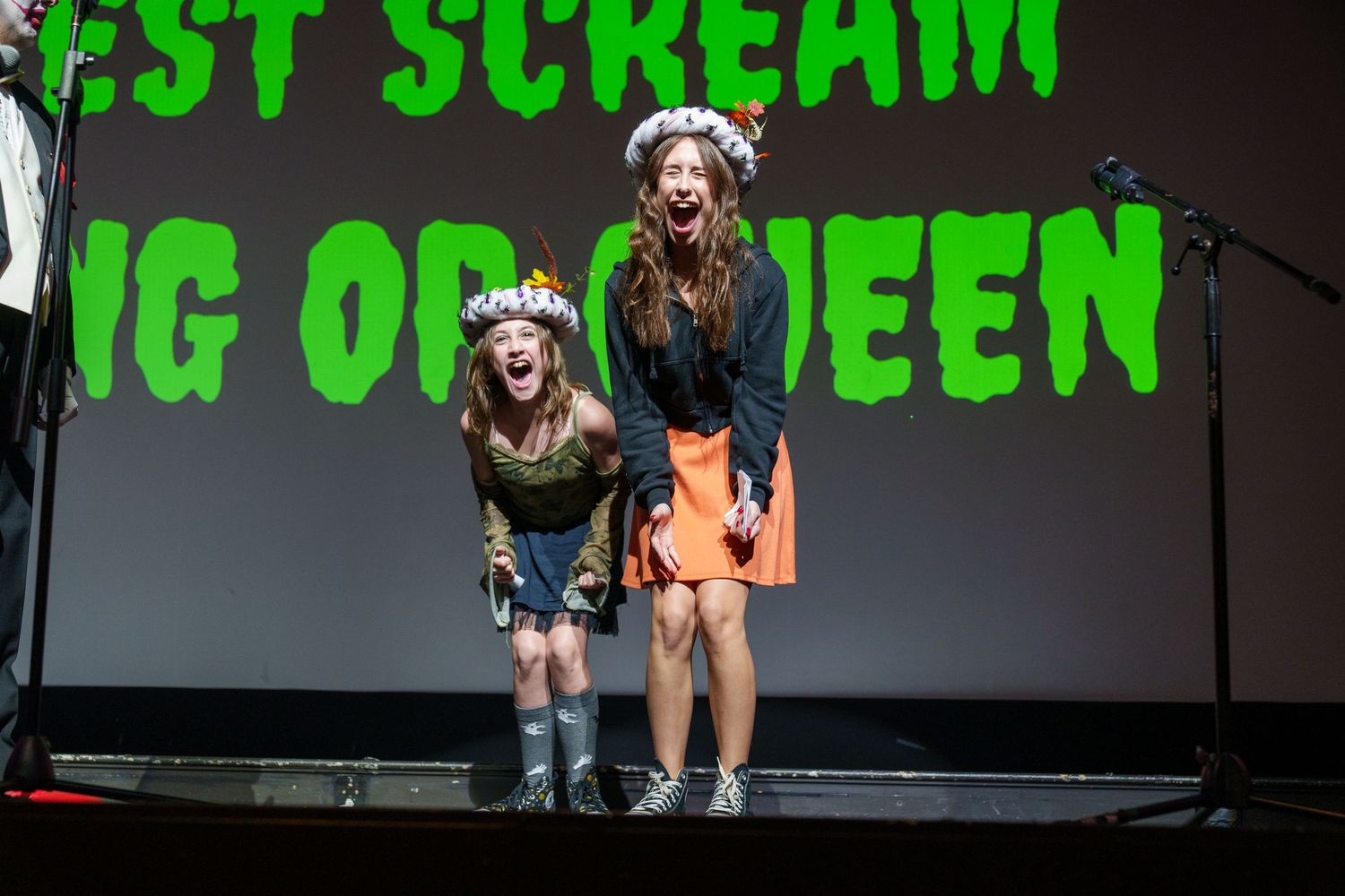 Halloween-themed stage setup with green text reading 'Scream' against dark background.