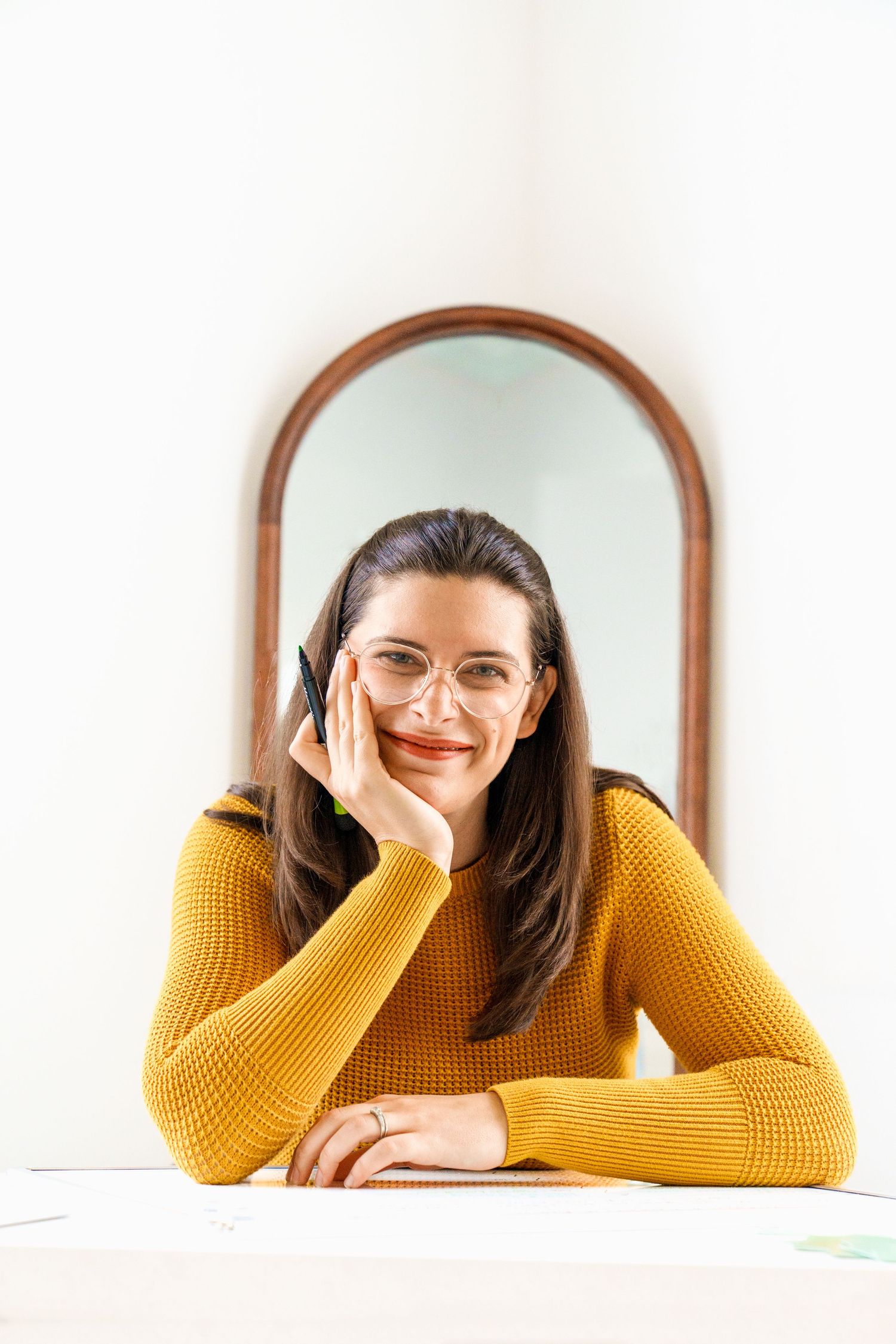 Mirror reflection portrait with yellow sweater and glasses.