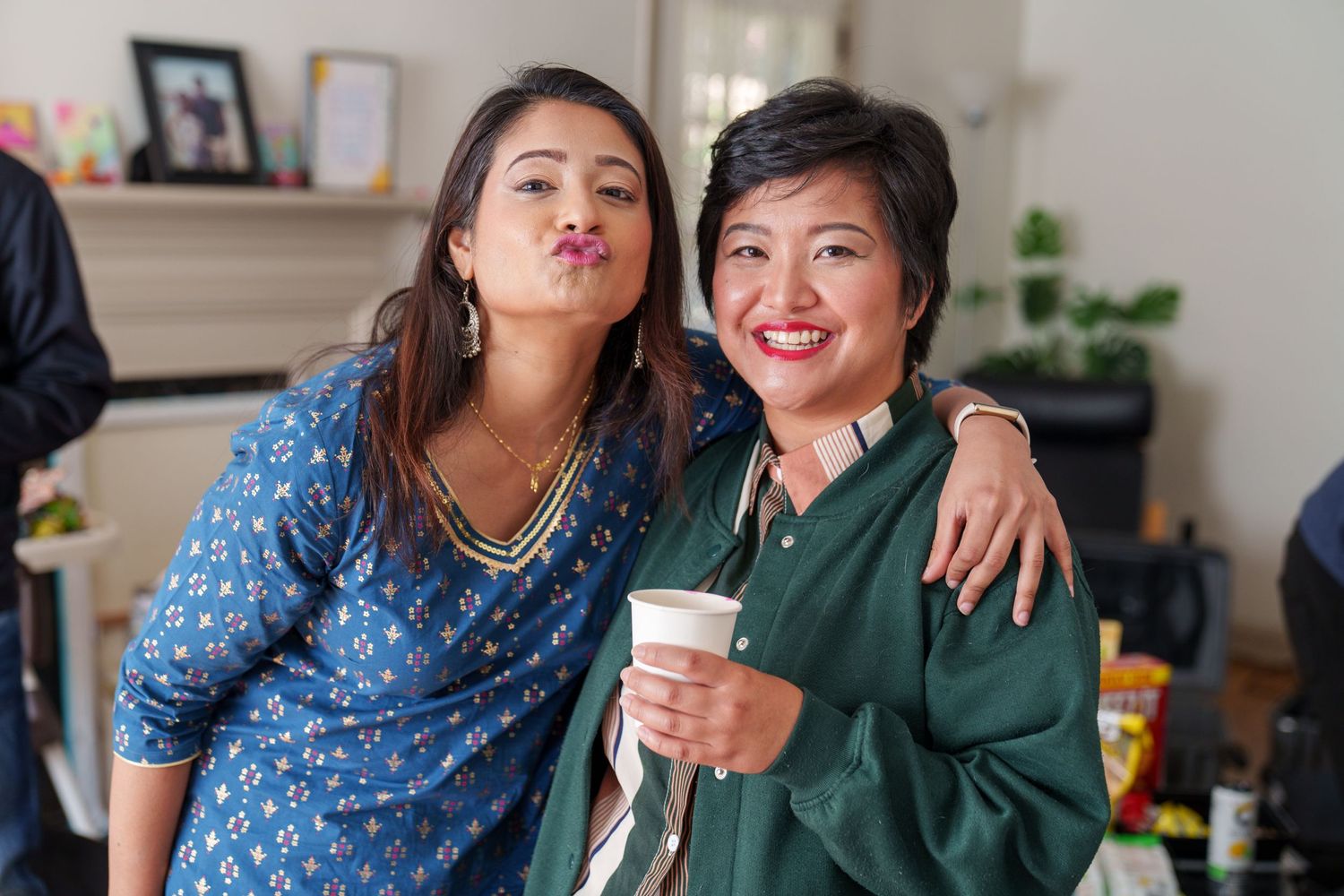 Friends in casual attire pose together making funny faces for the camera.