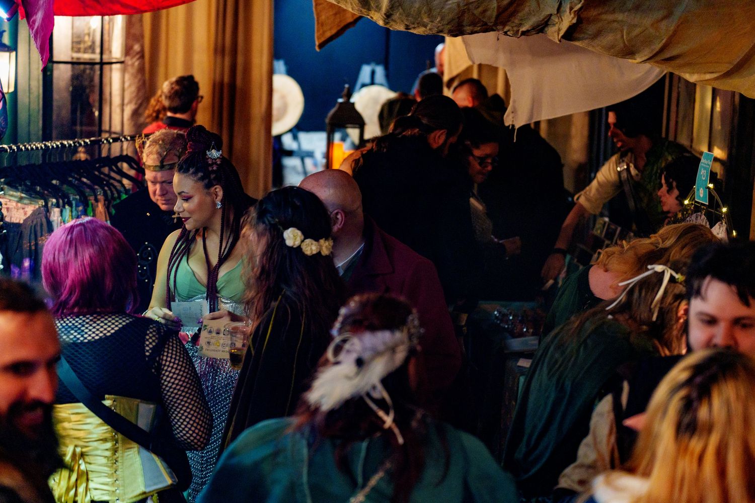 Crowded indoor party scene with colorful decorations and festive atmosphere.