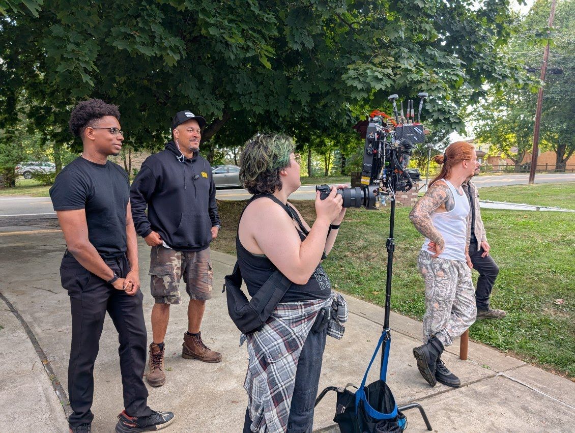 Group of people gathered outdoors in casual attire during a daytime event.