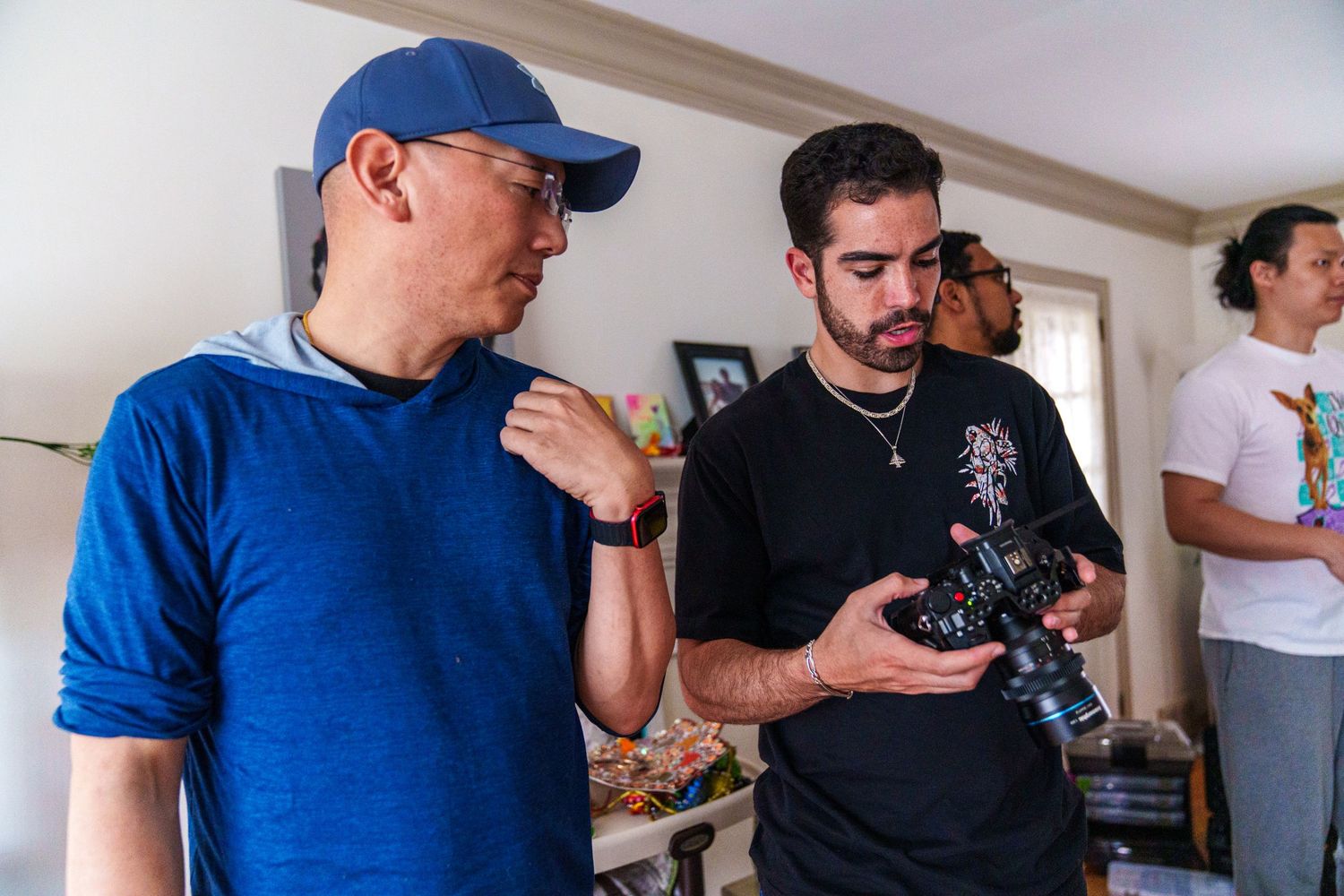 Two men reviewing footage on a camera during a film production shoot indoors.