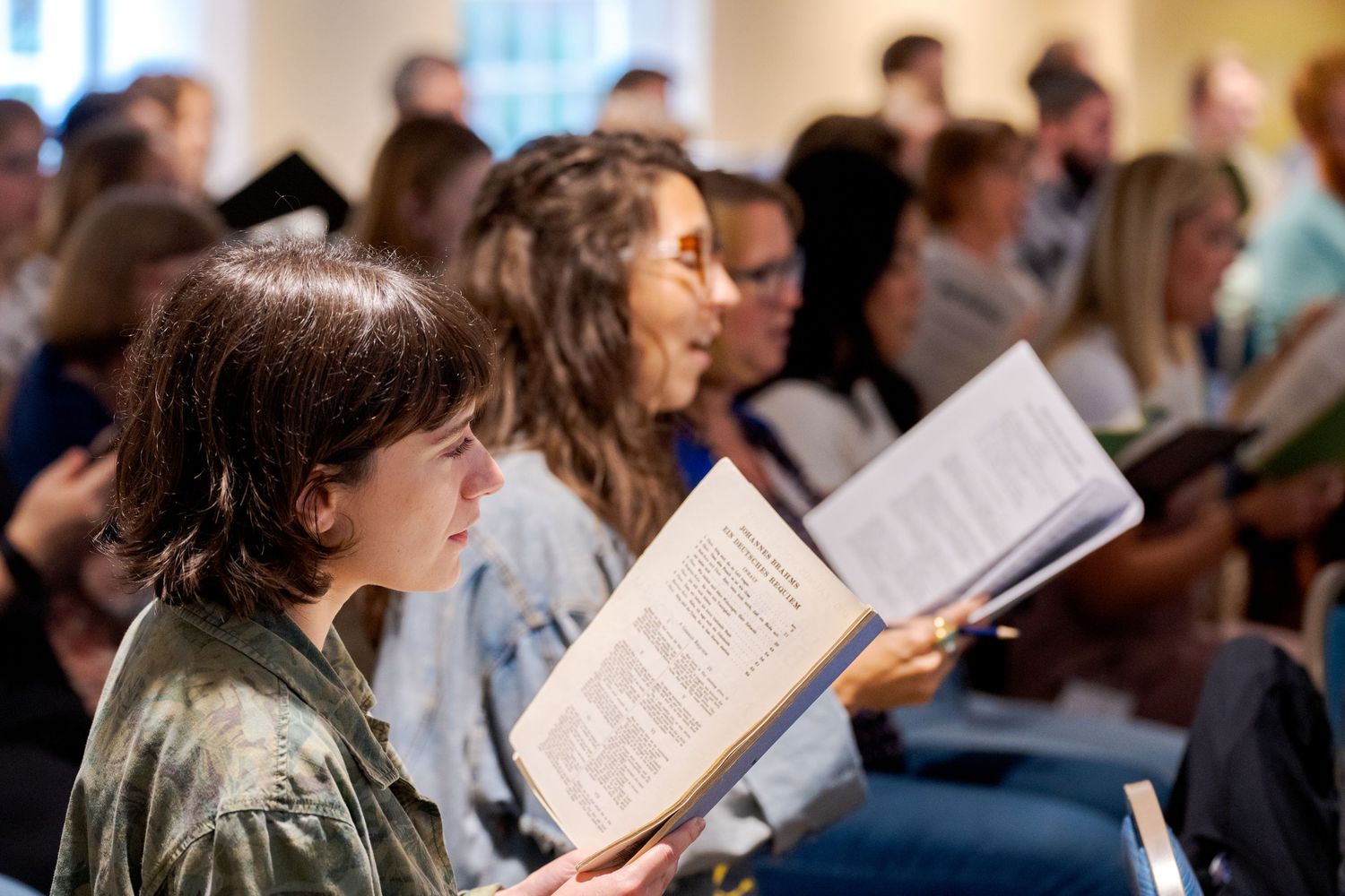 Congregation members holding hymnals during a worship service.
