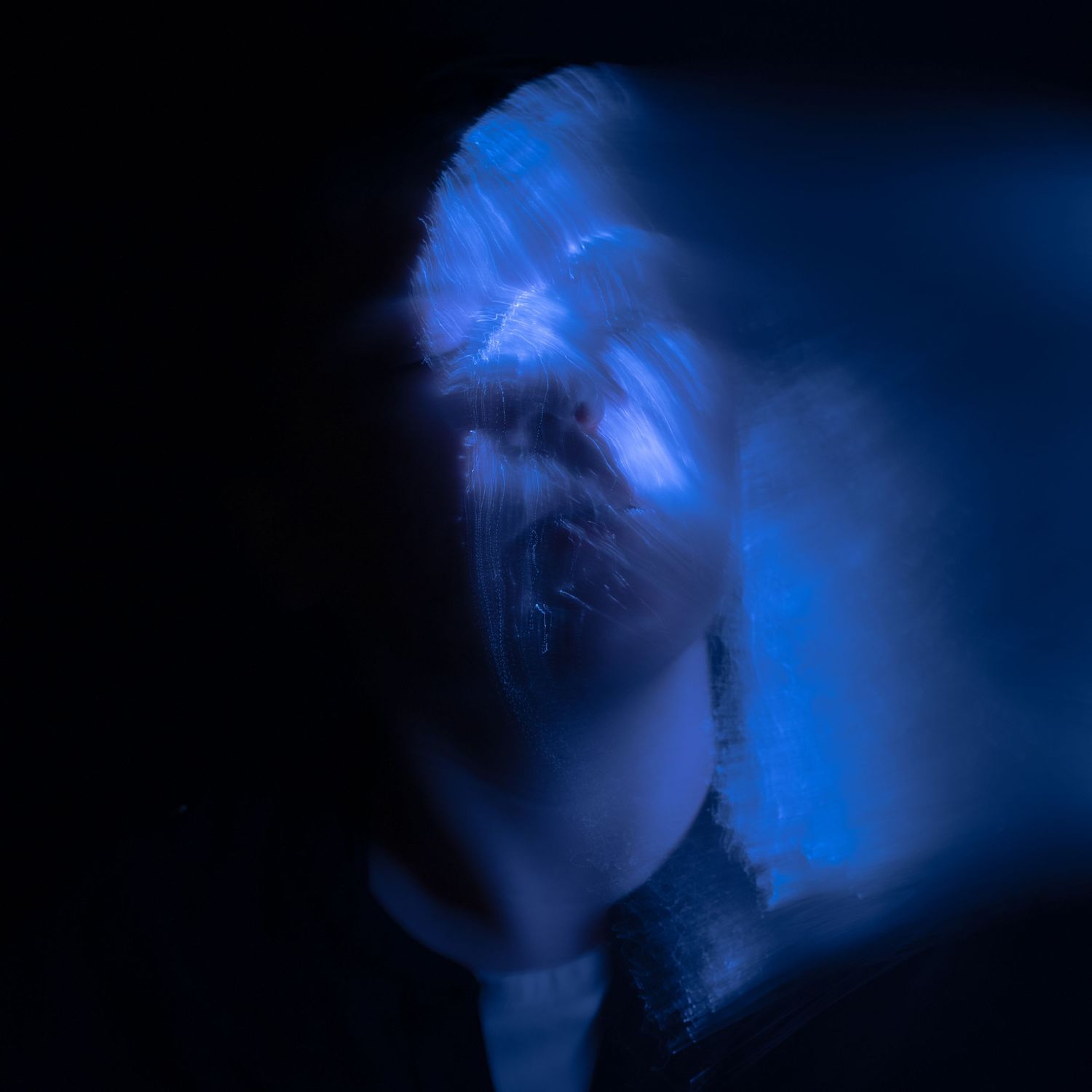 Ethereal blue light formations creating a ghostly effect in the darkness.