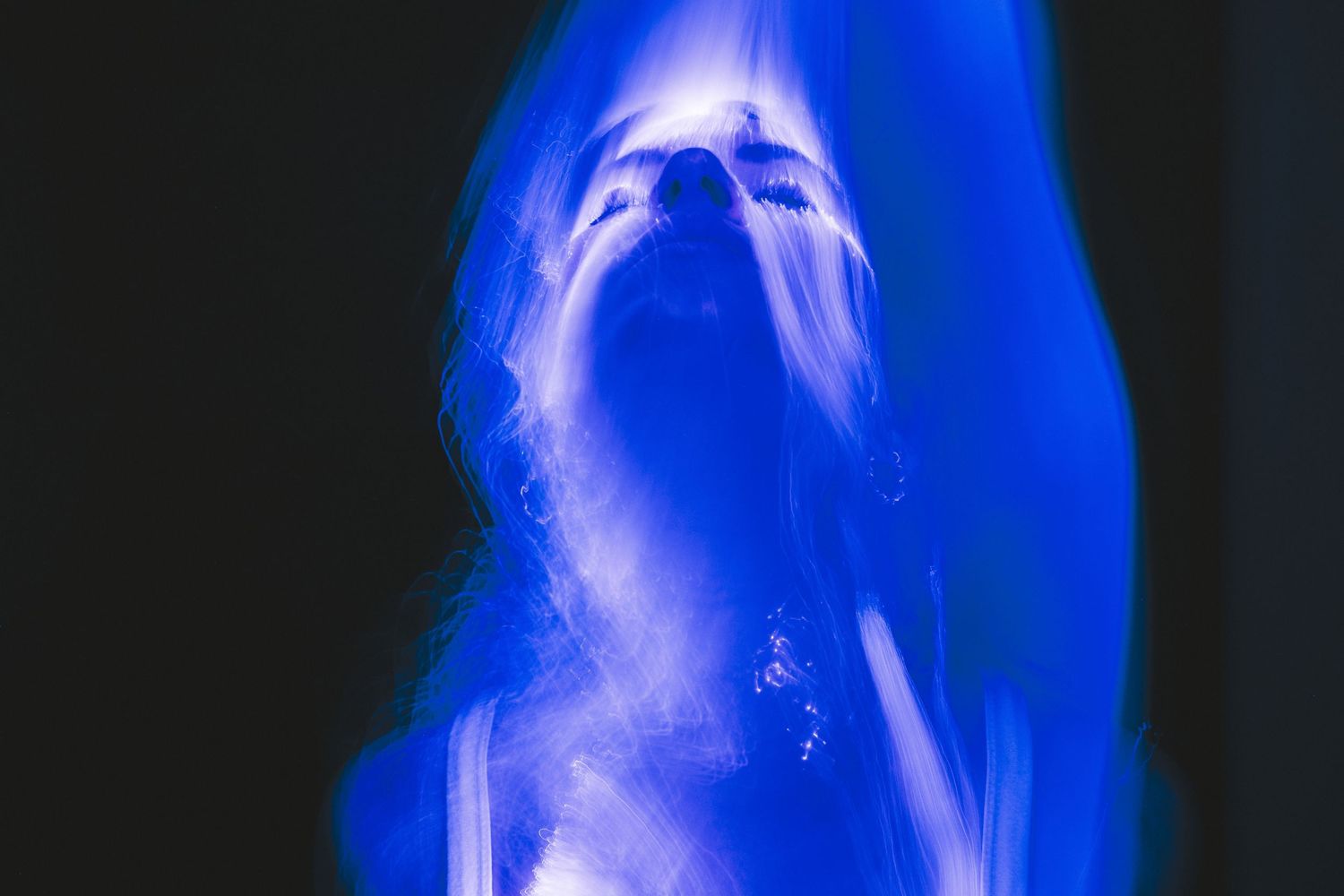 Vibrant blue light streaks create dynamic patterns in motion.