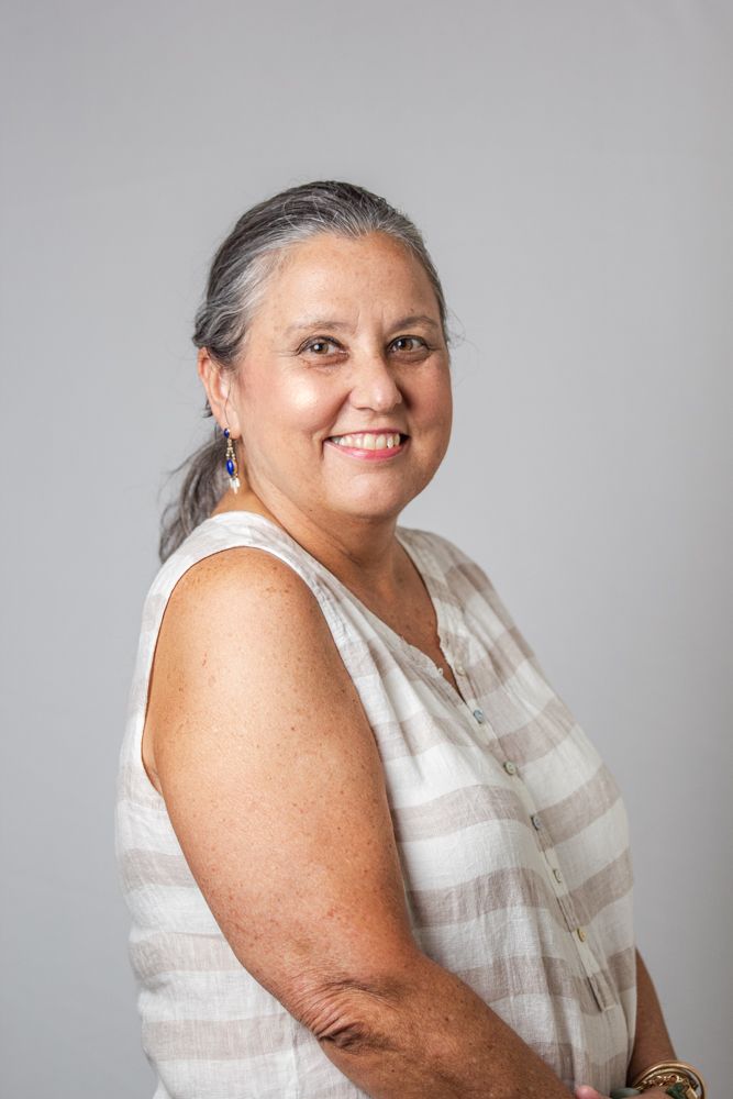 A person in a white sleeveless top poses against a gray background in a series of similar shots.